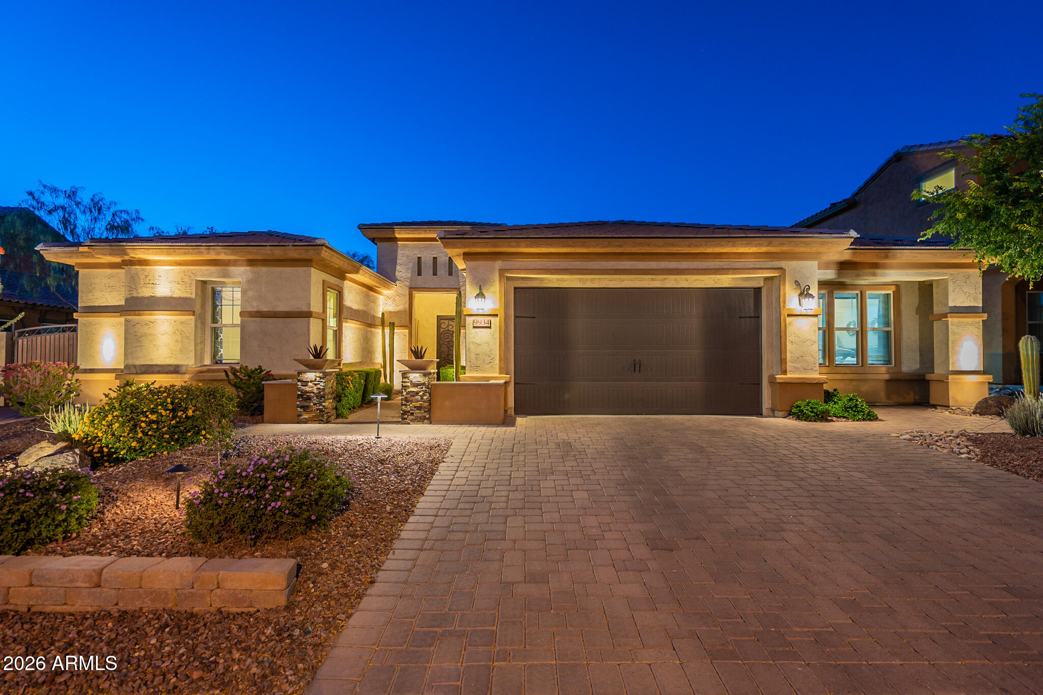 Welcome to Northlands Summit, a premier community in North Peoria. This elegant and spacious Whistler model was the builder's show home, and is located one of the valley's most incredible view lots. Sit back and truly enjoy the natural beauty of the Sonoran Desert skyline, with spectacular views of the Bradshaw mountains off in the distance. 3735 sq.ft of interior living space 4 BED + MEDIA ROOM + OFFICE + DEN + 3.5 BATH and a 2 Car Garage, RV Gate w/ paved driveway. Great curb appeal, beautifully lit and landscaped with a paved walkway and a covered entry. Elegant foyer with tile accents, two-tone tray ceilings w/crown molding and a glass chandelier. The front office features double doors, wall to wall built-in shelving, glass pendant and can lighting. Open concept main living area, light crisp color palette with sophisticated dark blue accents in the dining room and hall, light wood look tile floors, can lighting, with white trim and doors. The living room features a built in TV /media storage with large picture windows. Custom chef's kitchen features white cabinets, granite countertops and island w/ prep sink, tile backsplash, large glass bell pendant lighting, stainless steel appliances with range hood and a walk-in pantry for all your storage needs. Step into your spacious master suite, with bold beam accent ceilings, beautiful outdoor views and access to your private backyard. Full master bath features tile floors with mosaic accents throughout, separate granite vanities, soaking tub, large walk-in shower w/seating. 3 additional bedrooms, 2 full bathrooms, powder room, plus a spacious media room with built-in storage and a separate den provides you with all the space you'll ever need. 2 CAR garage, convenient RV gate with a paved driveway. Step outside and enjoy your private mountain views and the desert skyline, your outdoor retreat features open view fencing, a covered patio space, circular seating and serving bar area, built-in BBQ, a large pergola, plus a hot tub. There truly is nothing to do except move in. Neighborhood mountain views, bike paths, green spaces, walking and hiking trails. Close proximity to 303 freeway access, 8 min to Four Corners, a shopping and dining destination, 9 minutes to the 85 acre Paloma Park with lighted ball fields, pickleball, dog park, fish lake & deck, playground and picnic ramadas, 16 minutes to TSMC, shopping, dining, entertainment, health care, and serene Lake Pleasant within 20 min. providing you with a unique experience, countless water and outdoor recreations including boating, fishing, kayaking, swimming, relaxed paddle-boarding.