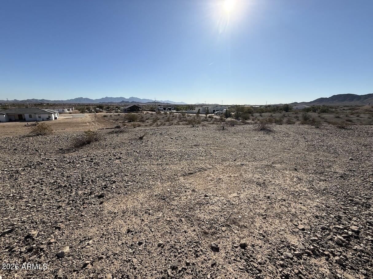 1 plus acre, great to build a special house for you and family, Horse property as well, surrounded by custom homes this land is in the hill with stunning views of the White Tanks and Estrella Mountains.