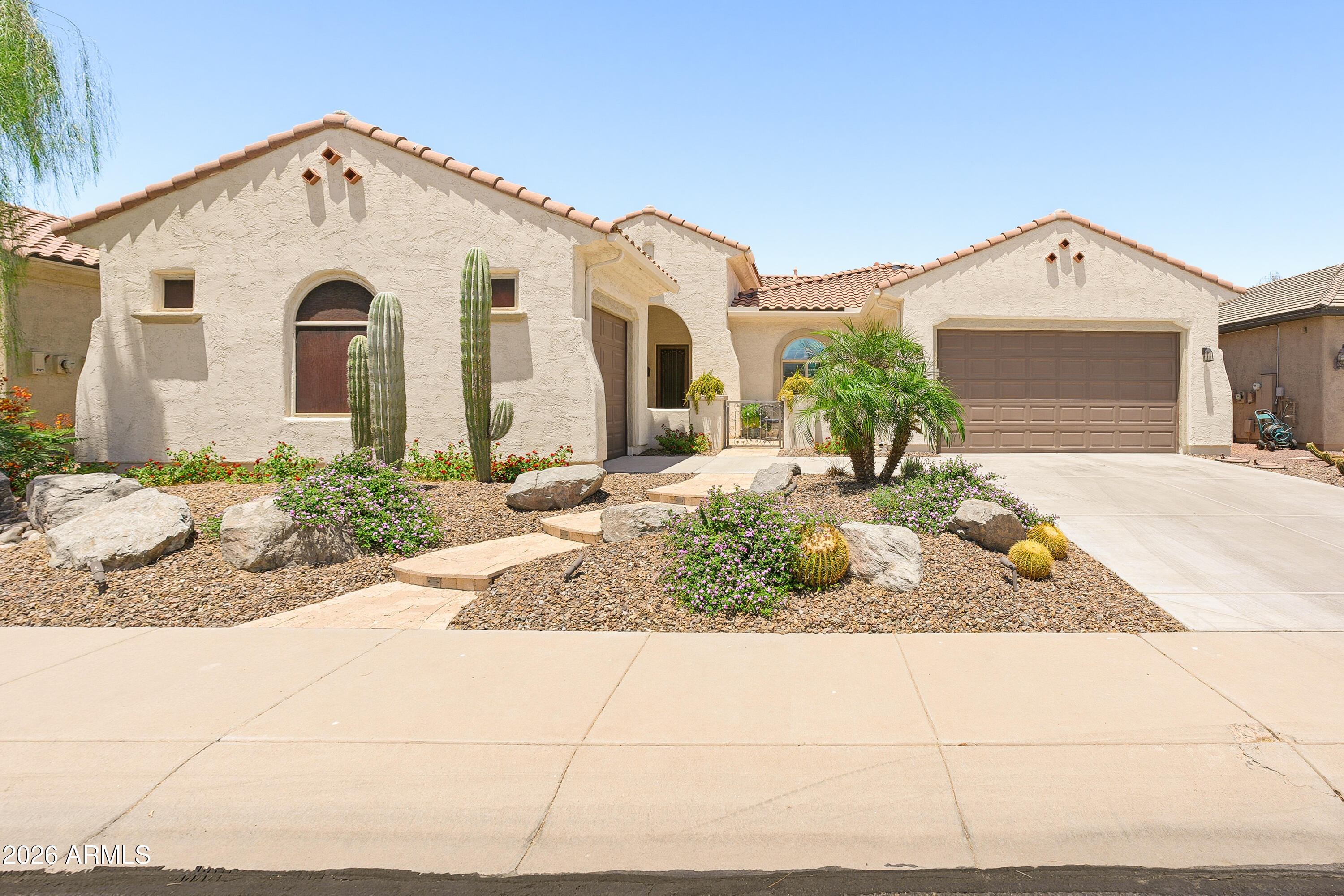 Looking for a backyard with open common area & green space? This beautiful Destiny model with Spanish exterior backs to scenic walking trails & is just steps from Mesquite Park. A private front courtyard welcomes you to this energy-efficient ''GreenBuilt'' home featuring an upgraded 2.7kW solar system, tankless water heater & cathedralized insulation designed to enhance comfort while helping reduce utility costs. The chef's kitchen showcases rich cherry cabinetry, elegant Uba Tuba granite countertops & a huge island. Wood plank flooring enhances both bedrooms. Enjoy an extended travertine patio, pergola, custom Pueblo outdoor fireplace & fire pit. Additional highlights include a detached 3rd-car garage. Privacy, views & an exceptional lifestyle await.