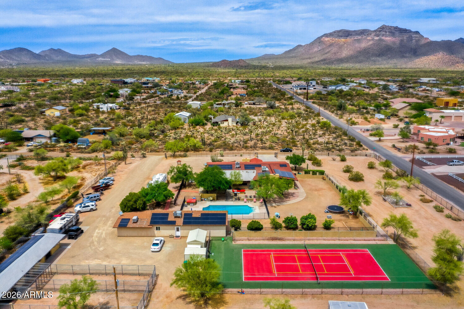 No HOA, equestrian-friendly, and offering 6 bedrooms, 6 bathrooms, a detached casita, and two RV pads, this exceptional 2.3-acre estate delivers refined rural living with breathtaking mountain views. Zoned for horses and fully equipped with horse stalls, a tack room, and an enclosed chicken coop, the property is ideal for those seeking space, functionality, and flexibility.

The fully renovated home is thoughtfully designed for comfort and versatility, featuring granite countertops, three fireplaces, and a flowing layout perfect for everyday living and entertaining. A finished basement adds valuable extra space for recreation, guests, or extended stays.

Step outside to your own private retreat--complete with a sparkling pool, relaxing spa, and a full tennis/pickleball court--perfect for hosting or unwinding under open skies.
Designed with efficiency in mind, the property includes solar energy and a private well, enhancing sustainability and long-term savings.
Enjoy peaceful, private surroundings with convenient access to nearby hiking, biking, and equestrian trails, as well as shopping, dining, and everyday amenities just minutes away.
A rare opportunity to own a private, fully upgraded estate with unmatched amenities and panoramic views.