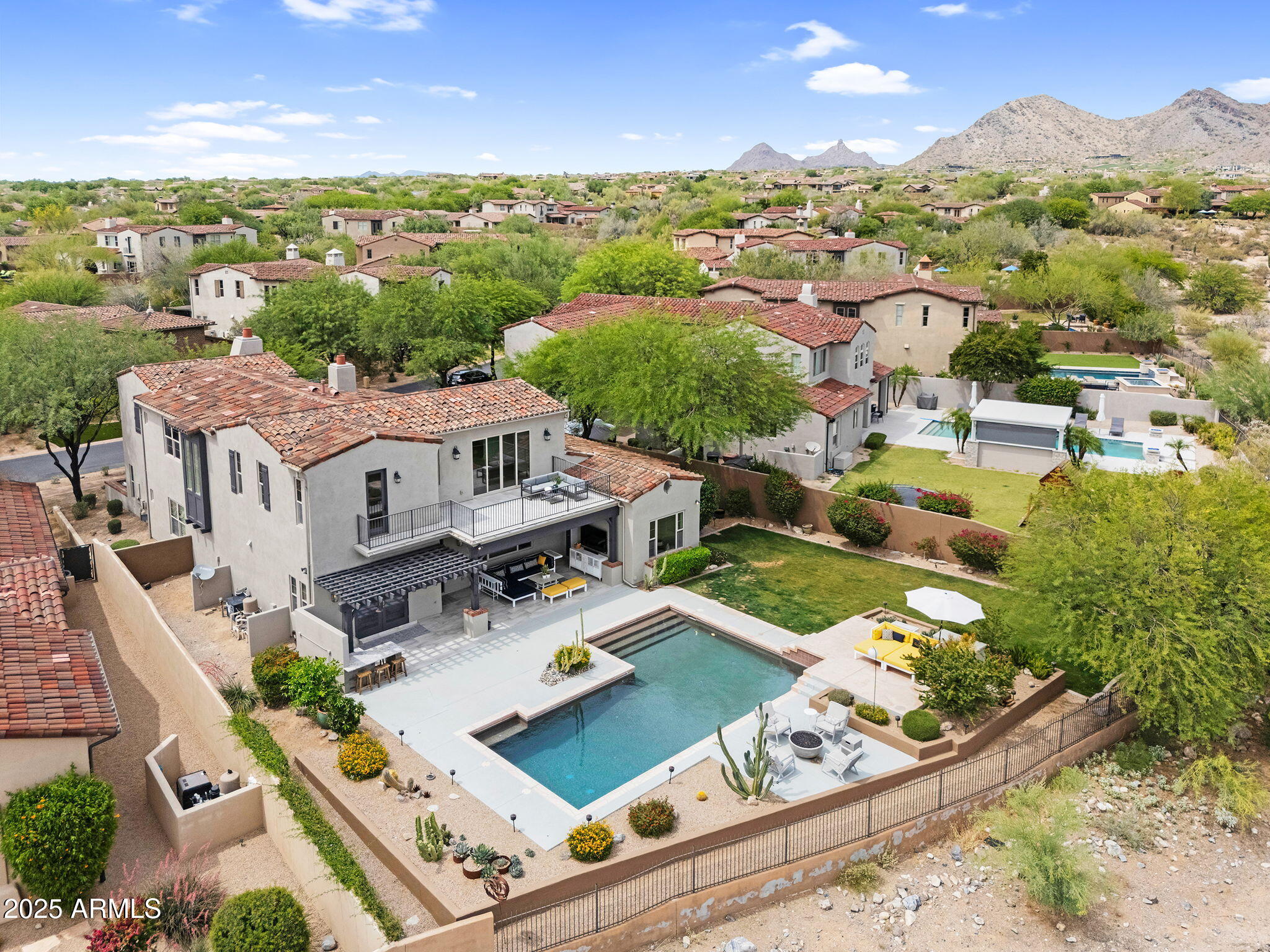Exceptional value in The Haciendas at DC Ranch. This spacious residence offers mountain views, timeless architecture, and an expansive backyard retreat. While thoughtfully updated, the pricing reflects an opportunity for buyers to bring their own vision and updates, creating a home tailored to their lifestyle. Rarely does a property of this caliber and location become available at such a compelling value in one of Scottsdale's most desirable gated communities.The beautiful interior features a main-level guest or flex room, hardwood floors, and a gourmet chef's kitchen that impresses with quartzite countertops, Sub Zero refrigerator, double ovens, 6-burner gas stove, and an oversized island. The adjacent pantry and bar area with wine refrigerator connect seamlessly... to the formal dining room for effortless entertaining.

The luxurious, spacious main-level owner's suite is a true retreat, complete with a cozy sitting area and dramatic mountain views. Its spa-inspired bath offers a soaking tub, walk-in shower, dual vanities, and a generous walk-in closet.

Upstairs, enjoy a private suite with an attached bonus/media room, plus two additional guest bedrooms with a shared bath ideal for family and visitors alike.

Step outside to a private resort-style backyard that backs to protected natural open space ensuring uninterrupted views and complete privacy with no neighbors behind. Take in panoramic scenes of the McDowell Mountains and distant Camelback Mountain from the elevated viewing deck. The outdoor space is ideal for both quiet mornings and vibrant evenings, featuring a sparkling pool, multiple lounge areas, and lush landscaping a secluded sanctuary for relaxation and entertaining under the stars.

Located near paved walking paths connecting directly to Copper Ridge School and just minutes from DC Ranch's vibrant Market Street dining and shopping district, this home offers both convenience and prestige. Enjoy exclusive access to DC Ranch's community amenities, including private parks, pools, fitness centers, and miles of scenic trails.

This is luxury living, redefined for today's discerning buyer. Welcome home.
