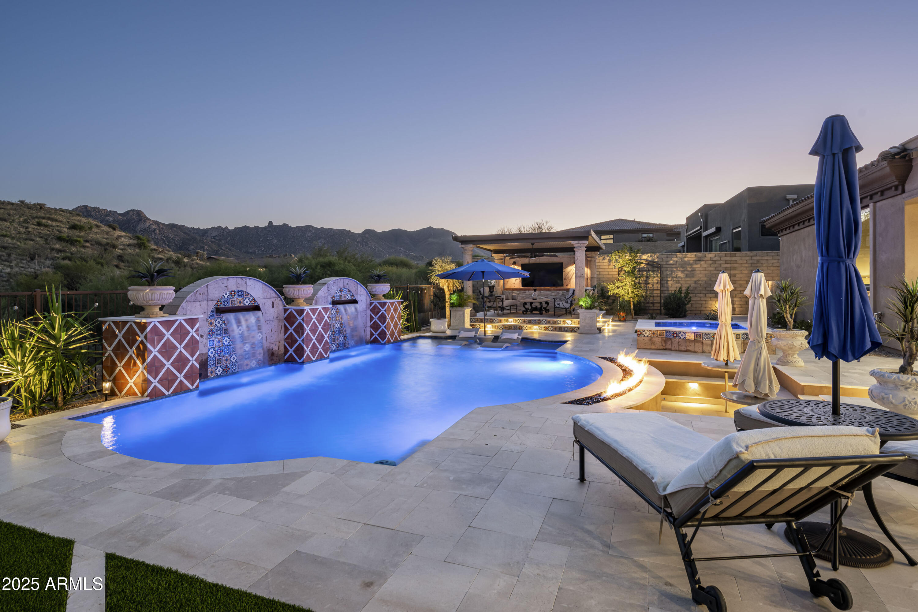 New construction in Storyrock!  This refined residence in one of  North Scottsdale's newest master planned communities blends Spanish revival architecture with modern comfort.  Coveted single level layout features open concept floorplan, split bedroom suites, and  light & airy spaces. Completed in Dec 2023, the home offers 3 bedrooms, 4 bathrooms and separate den over 4233 sf of beautifully appointed living space. A charming courtyard entrance sets the tone for the warm design, enhanced by wide plank oak flooring, designer kitchen features with wolf/subzero, quartzite and marble tops, wood beam ceilings,  and decorative accent wall tile that adds character throughout. Sweeping views of iconic mountain landmarks Tom's Thumb and the Four Peaks create a stunning setting.  Desirable south-facing lot backs to open space affording  amazing privacy and natural light.  The outdoor environment is ideal for entertaining on this spacious 2/3 acre lot featuring a elevated ramada, award-winning pool and spa, built in outdoor kitchen, large covered patio,  turf areas and a fire feature that anchors the space with a sense of resort style relaxation. The three car garage provides generous room for vehicles and storage, supporting both convenience and lifestyle.

This home offers a blend of beauty, comfort and thoughtful design in one of Scottsdale's most scenic settings.  Storyrock is a gated community located just a few miles east of Pinnacle Peak, known for it's pristine desert setting and  expansive views of Four Peaks and the McDowell Mountains. This is the Arizona you always imagined!!