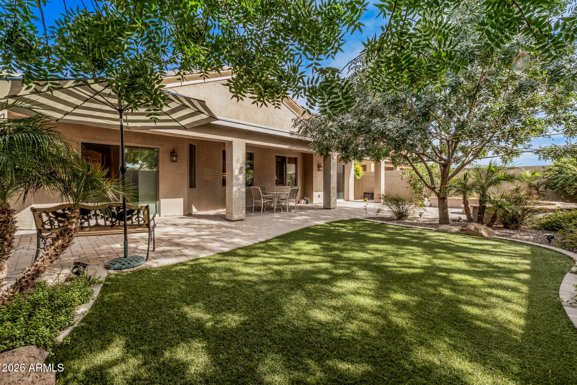Move-in ready home in Skyline Ranch offering 3 bedrooms, 2 bathrooms, and 2,028 sq ft of thoughtfully designed living space. The open floor plan seamlessly connects the living, dining, and kitchen areas, making it perfect for everyday living and entertaining. The kitchen features upgraded cabinetry with under-cabinet lighting, granite countertops, newer appliances, and a temperature-controlled pantry. The primary suite includes a private bath and a custom walk-in closet with built-in organization. Additional upgrades include plantation shutters, crown molding, two-tone paint, upgraded carpet, whole-house water filtration with reverse osmosis, and a functional laundry room with built-in cabinetry and workspace. The oversized 3-car garage features a mini-split A/C in the third bay. Enjoy a 1-year-old HVAC, 2-year-old water heater, landscaped backyard with covered patio, pavers, shade trees, and a fire pit. Just minutes from Queen Creek Marketplace, shopping, dining, parks, and other everyday amenities.