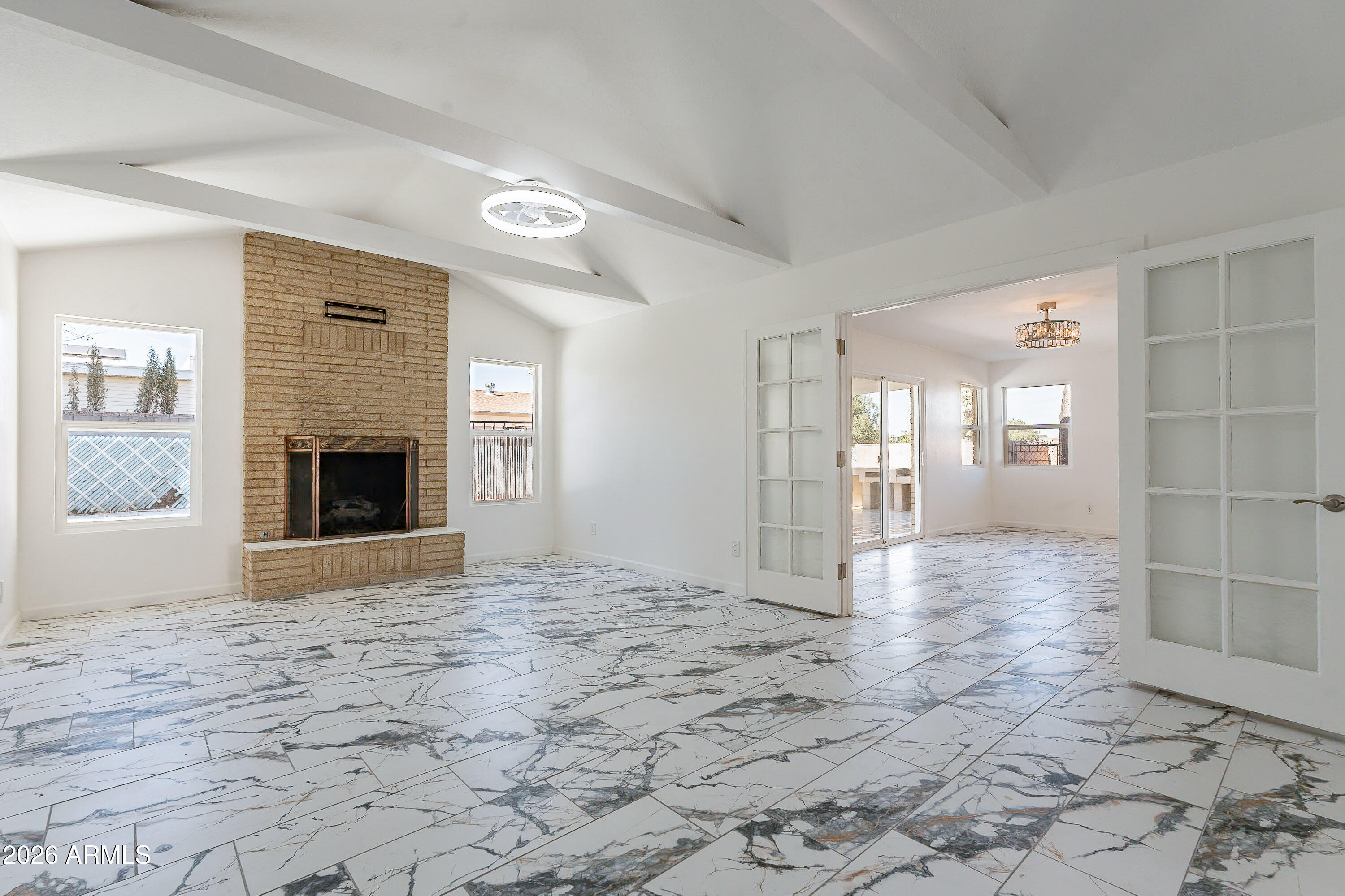 This house offers approximately 2,300 square feet of living space with four bedrooms and two bathrooms. The home features a spacious and open layout filled with abundant natural light, accentuated by vaulted ceilings and elegant flooring throughout. The kitchen is well-equipped with ample cabinetry and modern stainless-steel appliances, creating a functional and stylish cooking environment. The primary bedroom provides a tranquil retreat, while the additional bedrooms offer flexible options for use. The bathrooms are beautifully appointed with tile walls, glass shower enclosures, and elegant vanities, ensuring a spa-like experience. Stepping outside, the property boasts a spacious patio and ample outdoor space, perfect for relaxation and entertaining.