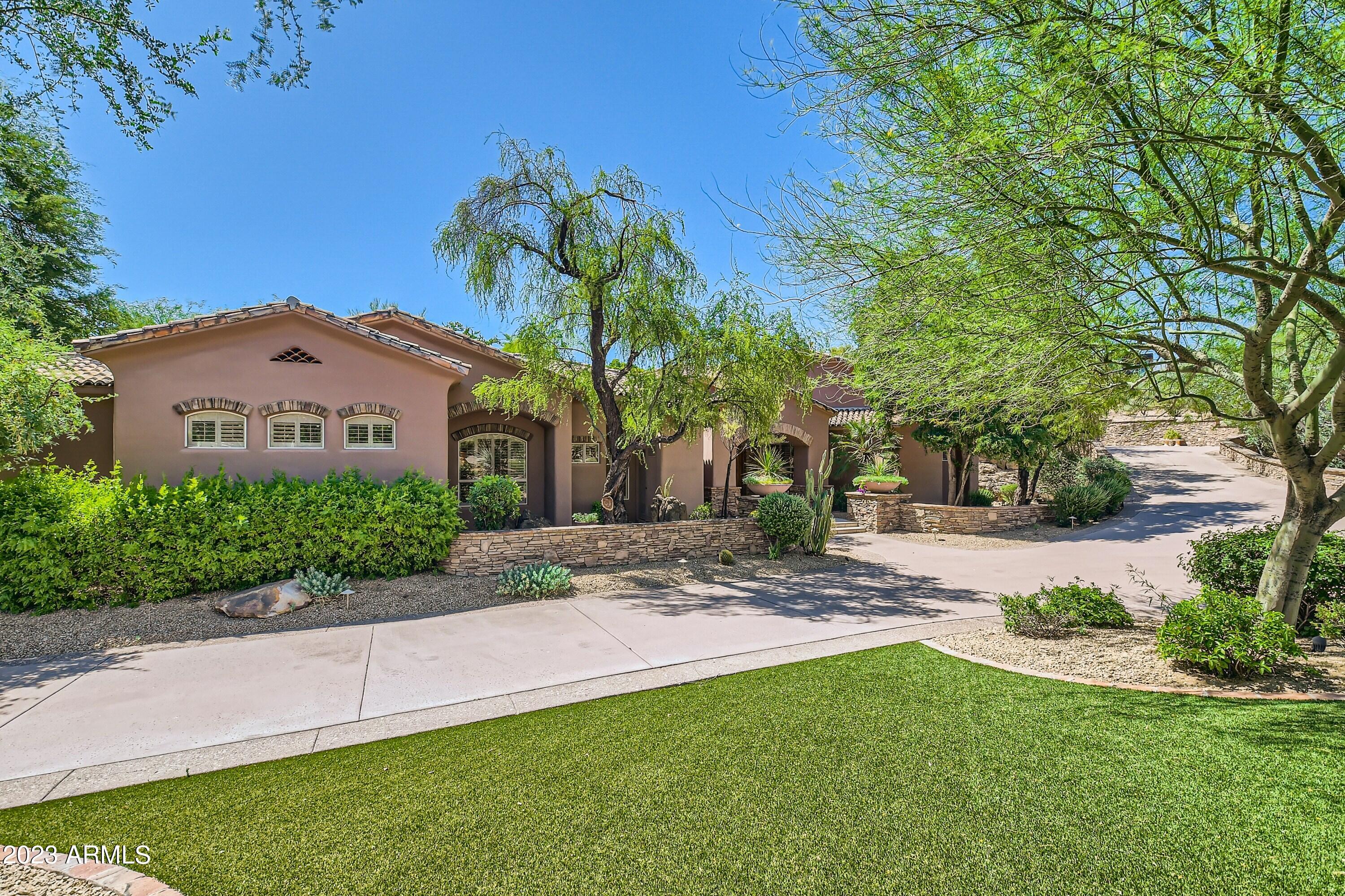 This one of a kind home located in the Heart of Paradise Valley boasts 5 bedrooms and 5.5 baths. In a very quiet location of Clearview Edition gated community. This home has beautiful mature trees that allow for ultimate privacy. Owners suite is located on the main level w/fireplace, sitting area and private patio. Oversized kitchen w/breakfast room opens to family room with full wet bar, fireplace, large patio with pool, spa, built in BBQ and more. Oversized 4 car side entry garage, circular drive, loads of storage, this home has it all...