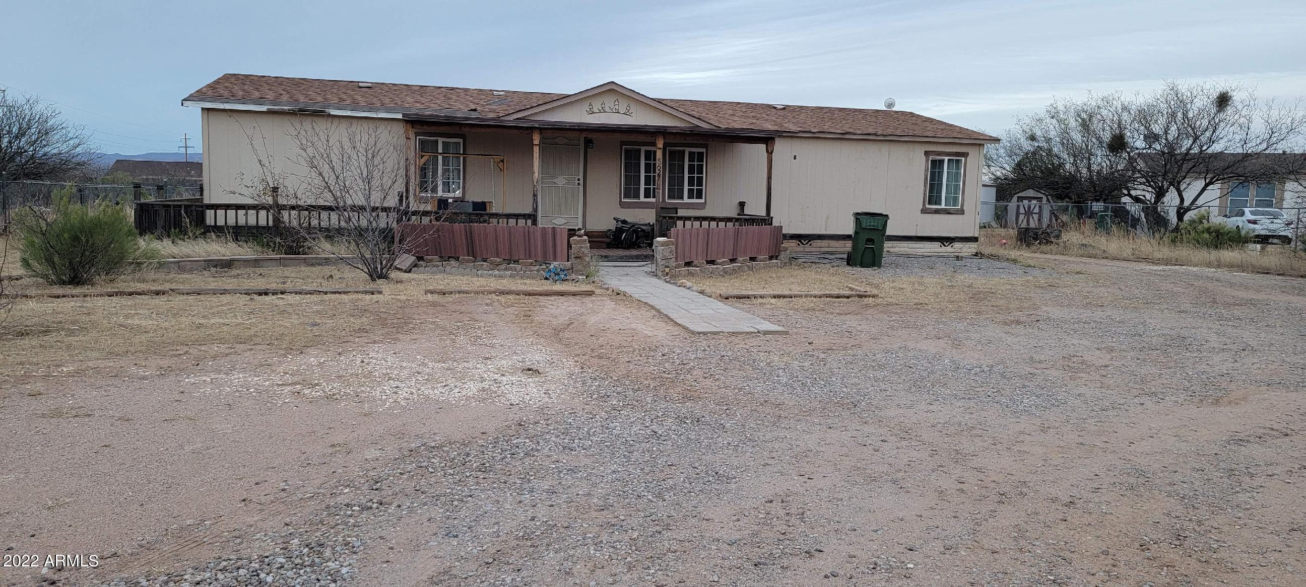 Beauty is in the eye of the beholder. This place has a lot of potential. Just under 1-acre w/ lots of potential to add. Enjoy sitting on the front deck facing the Huachuca mountains in the evening or off the back deck to watch the sunrise. Paid solar. The backyard has an additional deck area for a pool if wanted and a place for a hot tub. Split floor plan, three-bedroom, two-bath, open kitchen.
