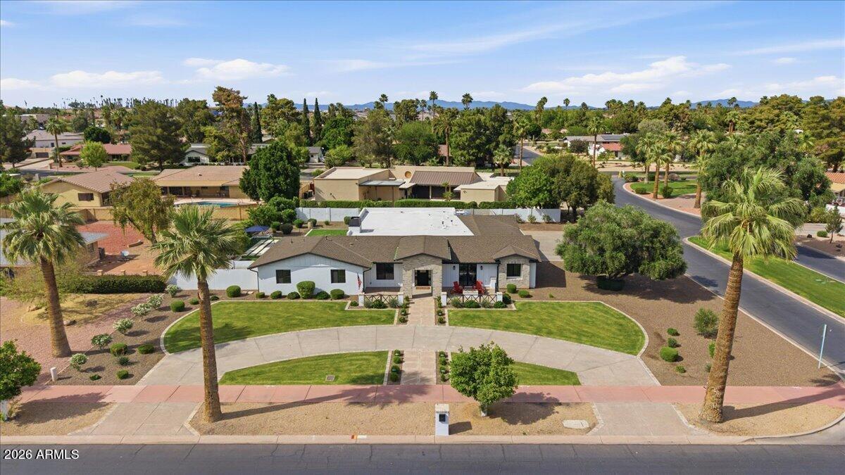 Welcome to this rare, fully renovated estate on Bird Lane, in the heart of Litchfield Park. This stunning 5-bedroom, 5-bathroom, PLUS additional den home has been thoughtfully redesigned with custom, high-end finishes throughout. From the moment you arrive, you'll notice the attention to detail, elevated design elements, refined materials, and a seamless blend of sophistication and coziness. Inside and out, spacious living areas are complemented by a beautifully updated finishes, offering both functionality and style for everyday living and effortless entertaining. Enjoy the views of the neighborhood, while sitting on the front patio, enjoying cooler Arizona sunsets around the fire pit. Enter through the custom steel and glass Dutch front door into a large great room. The family room features a cozy fireplace, with beautiful built-ins. The private den showcases a double-sided work station, and is adjacent to the gorgeous kitchen and dining area. The kitchen is highlighted by custom White Oak cabinetry, quartz countertops, stylish fixtures, and tons of storage and large walk-in pantry. With 4 full ensuites, each bedroom provides its own sense of privacy, while the bathrooms showcase designer touches and quality craftsmanship. Step outside to your private backyard retreat, set on a generous half-acre, corner lot, featuring a 2023 built pool with water features, and additional spacious area for entertaining. A full 3 car garage (plus room for a golf cart), and double-gated side yard offers flexibility for parking or storage, with full RV hook-ups. Fully renovated in 2021, including electric, plumbing, and a full primary ensuite addition, this is a rare opportunity, to live in Historic Litchfield Park, with fully modernized amenities. Located across from the Wigwam's Gold golf course, and a quick golf cart ride away from the famous Wigwam Resort in Old Litchfield Park; enjoy the lushness and beauty that only long-established communities offer. The Palm tree-lined streets, and incredible sunsets are truly postcard worthy. Just 30 minutes to Downtown Phoenix, this is the best of Arizona living. With easy access to local restaurants, bars, coffee shops, spas, and golf within the community; this hidden gem, has the feel of understated, resort-style living without being overdone. Small town feel, with access to all that makes the West Valley a true destination. The area features amazing art festivals, farmer's markets, Holiday celebrations, incredible parks, and more. With new developments, and more high-end retail coming to this established community, opportunity is calling.