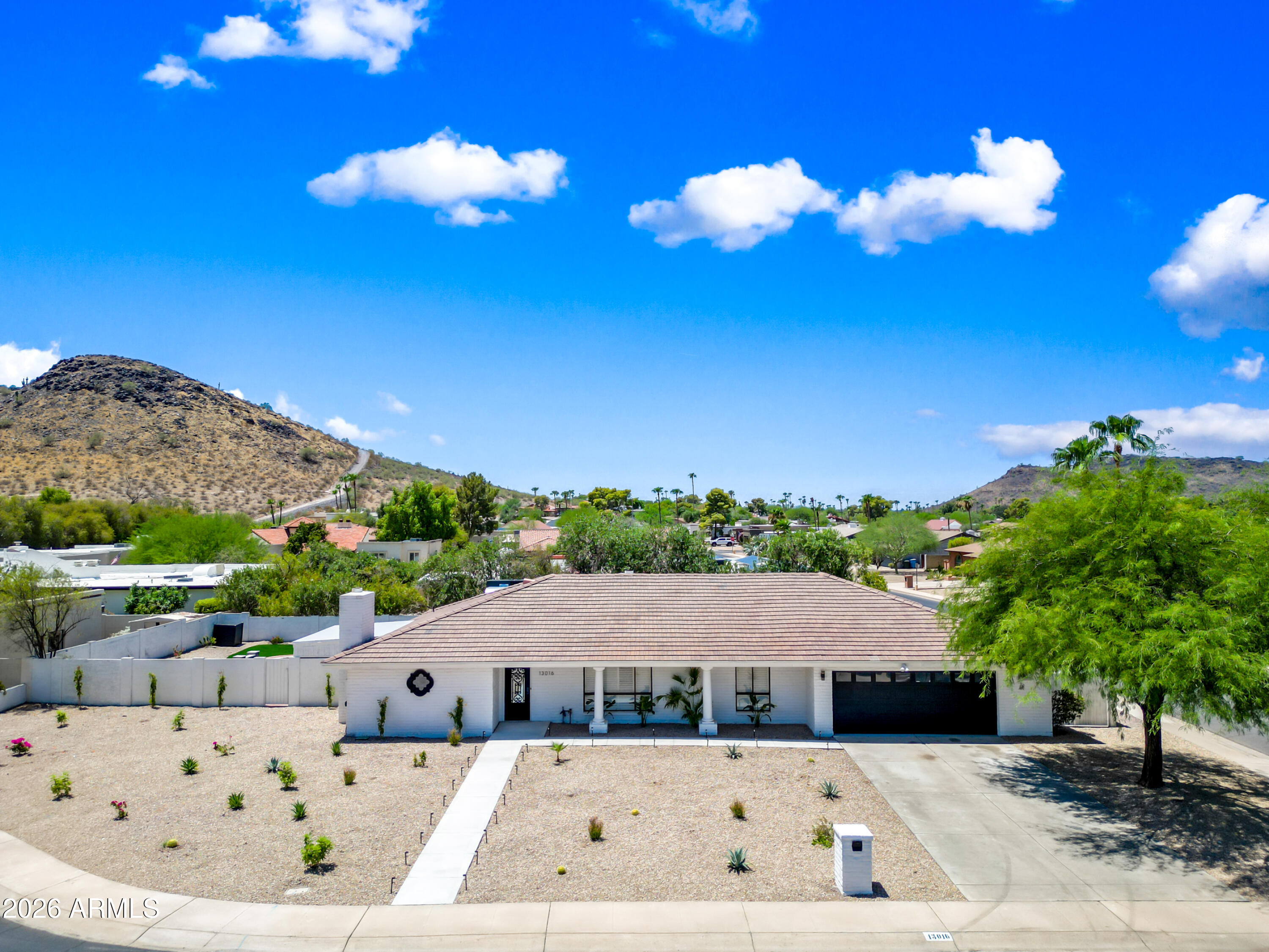 Experience elevated desert living in this beautifully remodeled home offering nearly 2,800 square feet of thoughtfully designed living space on an expansive 13,000+ square-foot cul-de-sac lot. Surrounded by breathtaking panoramic mountain views and located just moments from the renowned Phoenix Mountain Preserve hiking trails, this exceptional property perfectly blends luxury, comfort, and Arizona's natural beauty.  Step inside to soaring vaulted ceilings and an abundance of natural light that create an impressive sense of openness from the moment you enter. The stunning open-concept floor plan is centered around a showpiece kitchen featuring custom cabinetry, a spacious designer island, brand-new stainless steel appliances, and stylish finishes that make both everyday living and entertaining effortless. Designer lighting, premium hardware, and elegant fixtures complete the sophisticated aesthetic throughout the main living areas.

The luxurious primary suite is a private retreat, offering a spa-inspired bathroom with a beautifully appointed walk-in shower and a spacious custom walk-in closet designed for both style and functionality.

Step outside to your own private backyard oasis, where spectacular mountain views provide the perfect backdrop. Enjoy Arizona's beautiful weather from two covered patios or relax in the brand-new PebbleTec pool complete with a modern waterfall feature. The low-maintenance landscaping allows you to spend more time enjoying the resort-style setting.

Additional highlights include an RV gate with side-yard parking or storage, no HOA, and an unbeatable location just minutes from premier shopping, dining, entertainment, and top-rated amenities.

This is a rare opportunity to own a truly turnkey home in one of Phoenix's most sought-after neighborhoods, where luxury, convenience, and outdoor living come together in perfect harmony.