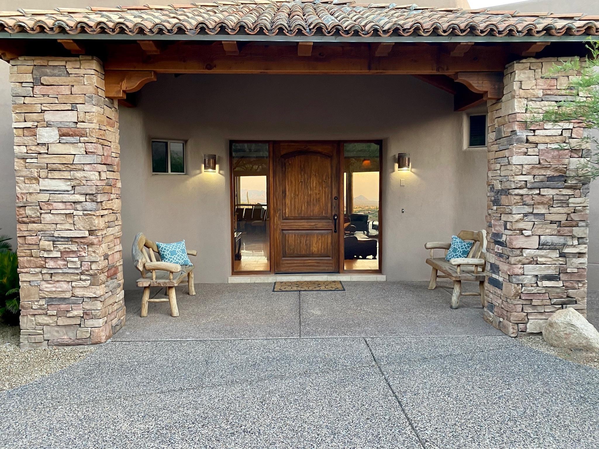 Don't miss this home! Don't miss these views! Stunning Santa Fe home has recently been refreshed and is located on an elevated corner lot. Open floor plan with 15 foot ceilings and custom alder doors. Top of the line finishes include granite countertops, travertine floors, and gourmet appliances. Pocket doors open to patio with negative edge pebble tech pool and spa, barbecue grill, and fire ring. 4 ensuite bedrooms in the main home and a great spacious 685 sq ft 2 room casita with mini-fridge and laundry. Office has a murphy bed. Home is being sold turnkey with fully stocked kitchen, linens, and other amenities. Membership to Desert Mountain, a private golf club with seven golf courses, tennis, hiking, swimming, bocce, pickleball, horseback riding, and croquet is available upon approval
