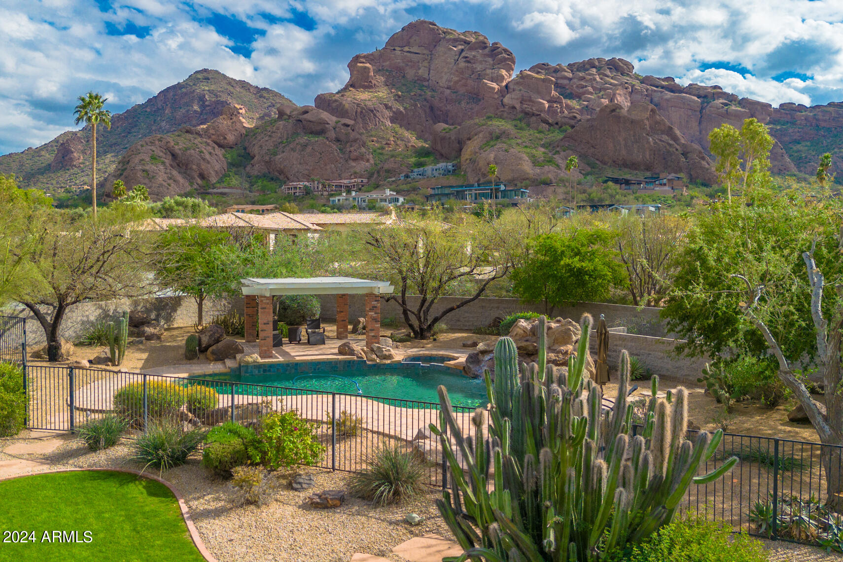 HOT NEW PRICE! Classic meets Location! Updated 1950's Ranch is tucked in on a near 2-ACRE lot! Paradise Valley prime location boasts views of Camelback Mountain & Praying Monk.  Desirable cul-de-sac lot offers privacy, possibilities to add a guest casita. NEW roof Dec 2023!! Double doors to grand foyer full of natural light from French doors, skylights and the openness of towering wood-beam vaulted ceilings. Huge dual+cedar closets. Impressive brick and wood flooring, wainscoting, built-in bookshelves accent this traditional beauty. Island kitchen W/granite, Subzero, 6 burner Viking gas stove + second oven. 360 bottle wine cellar! Kitchen opens to family rm w/ fireplace, inviting breakfast rm to enjoy the serenity of the private central courtyard. Room to build on this irreplaceable lot! An entertainer's delight offering formal dining and living room with second fireplace in addition to the welcoming kitchen.  Abundance of exterior amenities - Gazebo, heated play pool / spa, built-in BBQ, 4th car garage workshop with extra cabinets and 3 car side entry garage, large secluded driveway, front porch, N/S exposure, VIEWS to rave about! Priced below appraised value!
Be sure to watch the 360's and Drone Video!