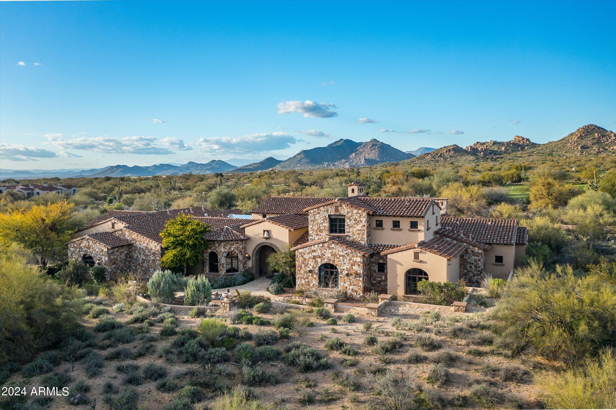 Mediterranean-inspired estate located on 2.5 acres in the guard-gated community of Whisper Rock Estates * Located on the 8th hole of the Lower Course, this property offers timeless architecture, views & privacy * Modern floor plan with kitchen opening to living and dining spaces, wet bar, media room and owner's office * Primary suite is complete with sitting room and stone fireplace, coffee bar and oversized bathroom & closet * Separate guest quarters with kitchenette, laundry and access to the backyard * Generous outdoor living spaces with covered patios, gas fireplace, heated pool & spa and putting green * Enormous 4-car garage with separate workshop completes the residence *