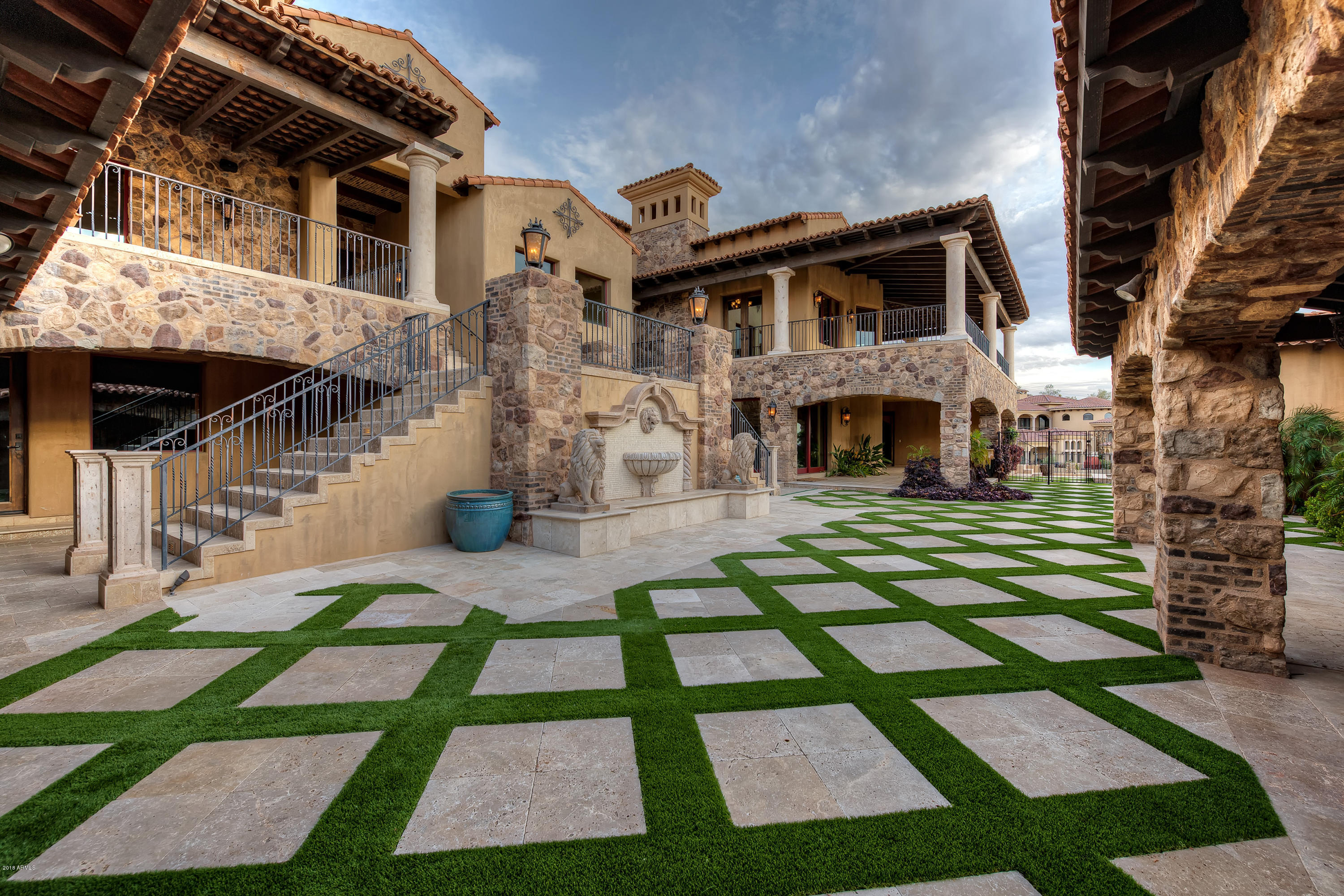 This stunning estate is perfectly situated on a gorgeous hillside behind the guarded gates of the prestigious community of Firerock Country Club whose golf club was voted best private golf club by Arizona Foothills Magazine. Its location is just minutes from Scottsdale and is a convenient commute to Phoenix Sky Harbor International Airport. This majestic masterpiece beautifully captures the Arizona Sonoran lifestyle with captivating panoramic golf course, water, and city light views from nearly every room. Sitting on almost two acres, the masterfully designed floor plan is perfect for intimate family living as well as the ultimate entertainment showpiece for hosting large special events.  See More... The interior details are as opulent as its exterior finishes with rich reclaimed wood flooring, exposed beams, recessed coffered lighting, soaring ceilings, disappearing glass wall of windows, hand carved cabinetry, smart home lighting, sound, and security all combine to make this manor not just a home, but an experience. The master chef's kitchen has Wolf, Viking, Scotsman, and Asko appliances, along with two additional full-service kitchens, and butler's pantry. The spacious master retreat has exposed beams, sitting area and private balcony with a luxurious two-story master bath with brick barreled ceiling and separate soaking tub/shower room. There is also a maid's/nanny's quarters, yoga/massage room, exercise room, home theater, tech room, temperature controlled 1100 bottle wine room with separate wine tasting area, backlit onyx wet bar, and billiards/game room. The grotto second family room has a full kitchen and powder bath off the double negative edge pool. There is an office with its own private entrance, an elevator and a separate casita with full kitchen, living room, bedroom, bath and patio. This home's own private gated entrance and motor court, adds an extra level of security and exclusivity to this estate. To get a full picture of this stunning home, you really must see it. What sounds like a dream can definitely be your reality!
