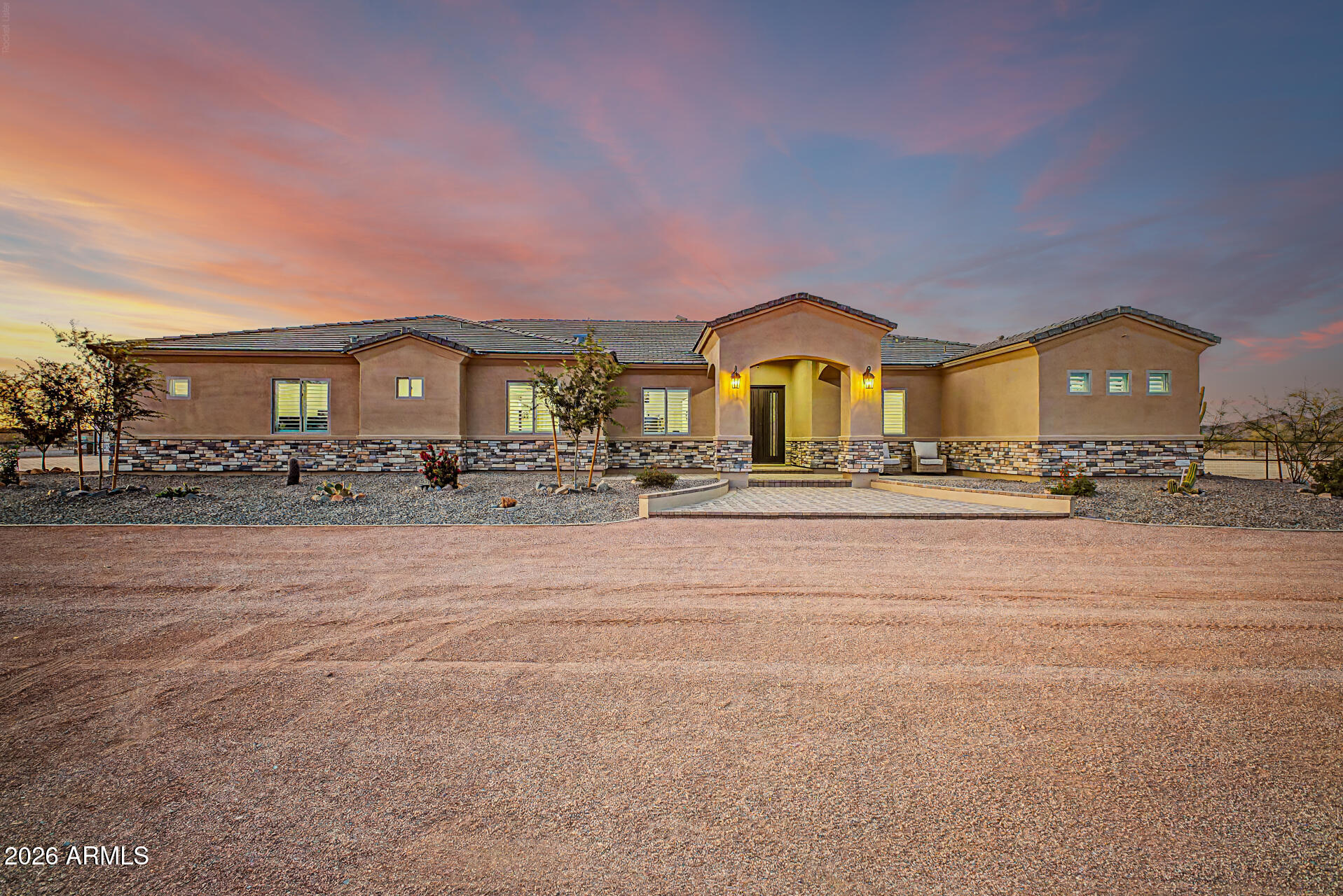HIGHLY SOUGHT OUT SAGUARO VIEW NEIGHBORHOOD WITH 2.5 ACRES. THIS AMAZING CUSTOM HOME BACKS UP TO STATE TRUST LAND AND HAS THE MOST AMAZING VIEWS. FIRST THING YOU NOTICE WHEN PULLING ON PROPERTY IS THE CURB APPEAL TO INCLUDE LUSH LANDSCAPING, A GRAND PAVER ENTRY WITH AN  OVERSIZED IRON DOOR, AND STONE ACCENTS ON HOUSE THEN AROUND TO THE 55'X80' PAVER PARKING. ONCE INSIDE YOU REALIZE THIS IS IT!! THE KITCHEN IS AMAZING WITH JENN-AIR APPLIANCES, A MASSIVE BUILT IN REFRIG/FREEZER, AND BEAUTIFUL NAUGHTY ALDER CABINETS WRAPPED IN 3CM GRANITE. THE 9X48 WOOD GRAIN TILE FLOORING THROUGHOUT THE HOUSE IS BOSS AND EASY TO MAINTAIN! THE MASTER BEDROOM HAS A TRAY CEILING, OVER THE TOP BATHROOM AND MASSIVE 11X13 CLOSET WITH TONS OF STORAGE. BEDROOM 2 IS DIRECTLY ACROSS FROM ANOTHER AMAZING BATHROOM WITH AN EXTERIOR DOOR. THERE IS A COZY OFFICE IS DIRECTLY ACROSS FROM THE GAME ROOM. BEDROOM 3&4 SHARE A JACK AND JILL. THE 8X17' LAUNDRY ROOM  INCLUDES TONS OF STORAGE, ICE MAKER, COUNTER SPACE AND ROOM FOR 2 FULL SIZE DEEP FREEZERS. SOME GOODIES INCLUDE ANDERSON WINDOWS, EMTEK DOOR HARDWARE, SPRAY FOAM INSULATION, PREWIRE FOR SURROUND SOUND AND SECURITY CAMERAS. THE HOME HAS A 1435 SQFT OVERSIZED GARAGE AND A 40X60 SHOP! BOTH GARAGES AND ARE AIR CONDITIONED,HAVE SPRAY FOAM INSULATION, R-19 GARAGE DOORS AND JACK SHAFT OPENERS. THE BACK PORCH IS COVERED IN PAVERS AND THERE IS A PAVER WALK TO THE R/V GARAGE AND DRIVEWAY. THE BACKYARD HAS 5' DOUBLE POLE HORSE FENCING WITH NO CLIMB AND 4 GATES, PERFECT FOR JUST ABOUT ANY SET UP! ALSO THE CITY OF SURPRISE IS STARTING ON THE ROADS THROUGHOUT THE NEIGHBORHOOD COMING EARLY 2027. THEY HAVE THE MONEY ALREADY SET ASIDE TO ASPHALT THE ROADS JUST WAITING ON THE G&D TO BE COMPLETED! DID I MENTION THE VIEW!!!!!!!