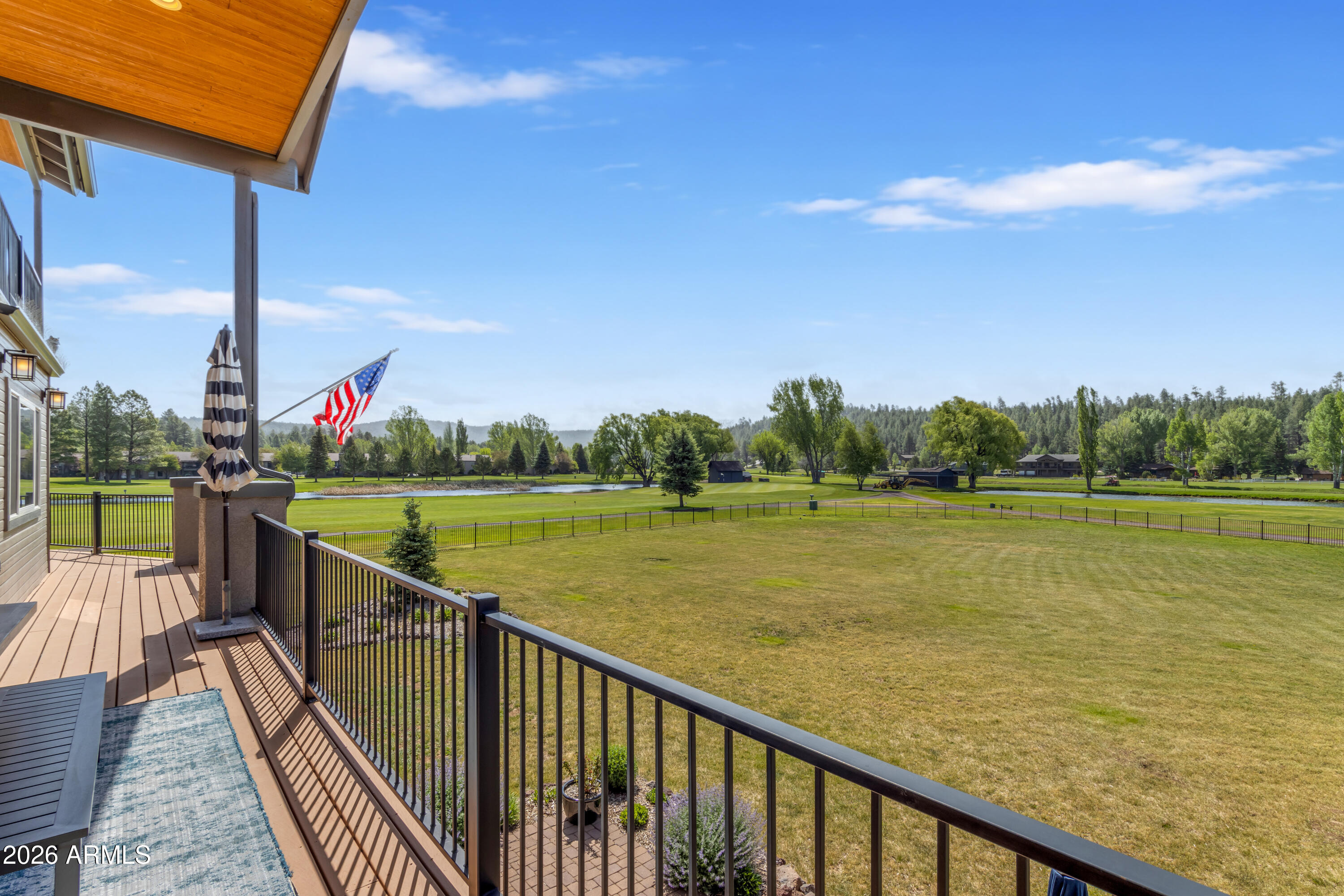 One of the finest lots in Munds Park. Situated at the end of a quiet road on over ¾ acre, this fully furnished 5-bed, 4-bath cabin sits directly on holes 1 and 2 of Pinewood Golf Course -- offering a rare combination of sweeping fairway, pond, and forest views with exceptional privacy. Inside, soaring cathedral ceilings and a wood-burning fireplace anchor the main level, while a gourmet kitchen with quartz countertops makes entertaining effortless. Step outside to the large covered deck, where cool mountain summers set the perfect backdrop for grilling, dining, and gathering with family and friends. The walkout lower level continues the entertaining theme: a full bar, poker and game room, bumper pool, shuffleboard, and generous storage and laundry. A 2-car garage + AC/Heating Tops it Off! Starlink internet, and central A/C-heat round out a property that's as functional as it is beautiful. With luxury new builds rising on the same street, this is a rare opportunity to own one of the finest lots in the community -- meticulously maintained and move-in ready.