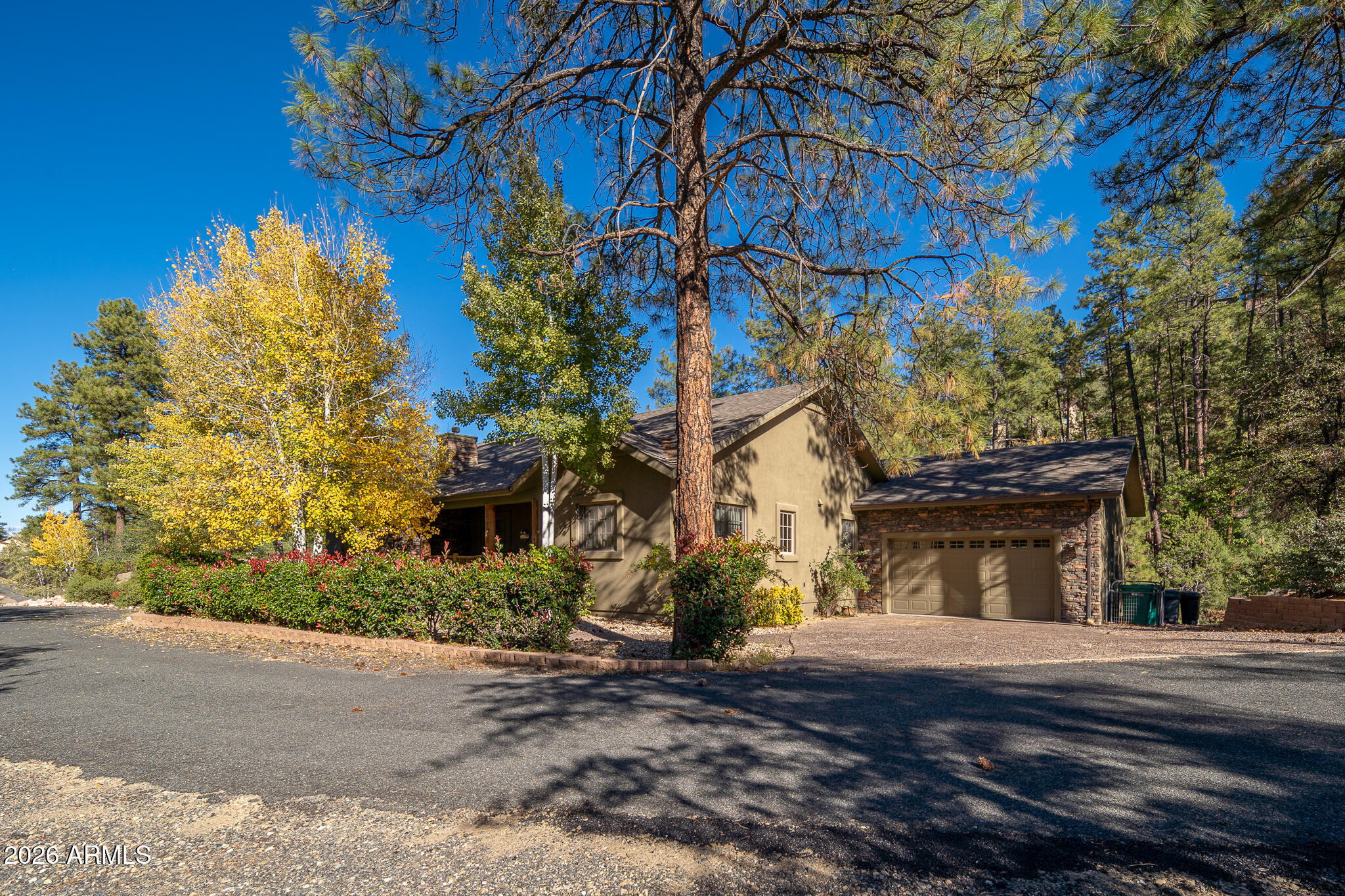 Private Prescott canyon retreat on approximately 1/2 ACRE LOT - NO HOA, backing to a seasonal creek and natural wildlife habitat . 2 miles from downtown and 1 mile to Safeway. This FURNISHED home offers hardwood floors, skylights, gas fireplace, STEAM ROOM shower in primary, and a den with coffered wood ceiling and French doors. Large balcony off kitchen/family room is plumbed for gas BBQ. Lower level features custom game room with mini kitchen/bar and separate entertaining space. Rare ATTACHED 4 BAY RV GARAGE + oversized 2 car garage, custom cabinets in both, compressor plumbed for both garages, large WORKSHOP/CRAFT ROOM with A/C and private entrance, CENTRAL VAC, irrigated landscape, and tons of storage.