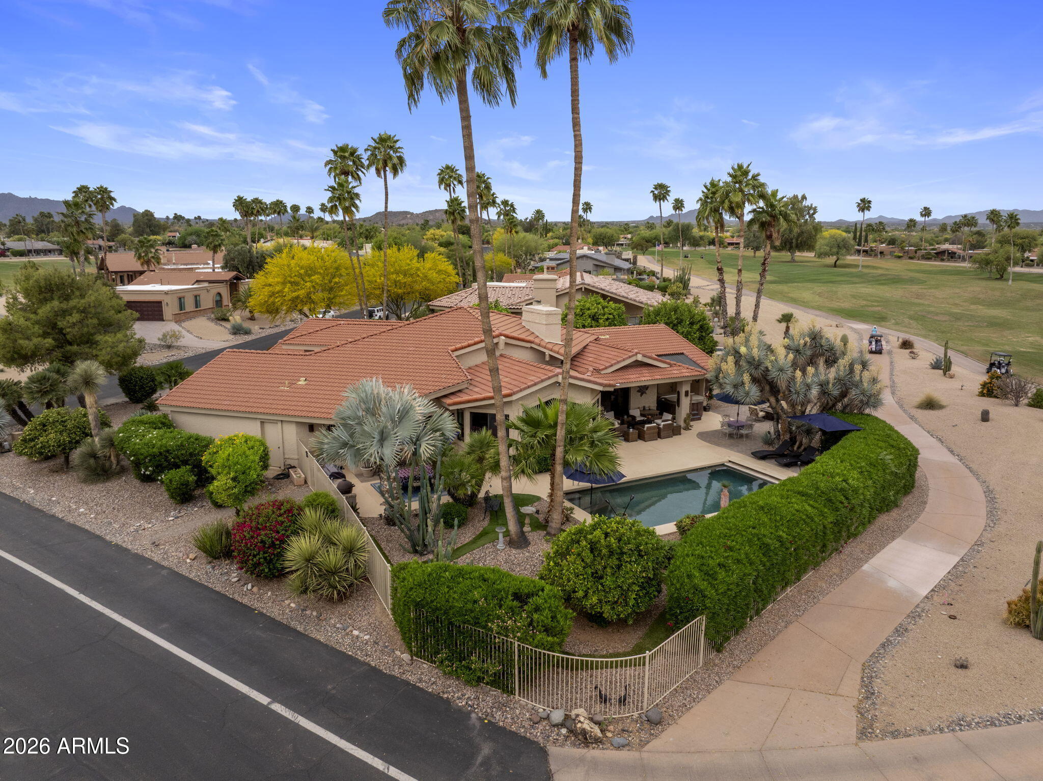 Rare Rio Verde offering: this bespoke 3,180 SF residence artfully combines elegance, space, and sweeping mountain vistas. Three bedrooms, 2.5 baths, a sophisticated office and multiple living rooms afford refined daily living and gracious entertaining. Dramatic 18-ft ceilings and a stacked-stone fireplace anchor the great room; the upgraded kitchen flows to a generous game/family room with built-in wet bar, ice maker and sink. The primary suite is a serene retreat with sitting area, fireplace, spa bath and oversized closet. Outside, a private oasis -- heated pool, mature landscaping, citrus trees and unobstructed desert views. Complete with a 2-car garage, double golf-cart garage and abundant garage storage, this home epitomizes the Arizona lifestyle.