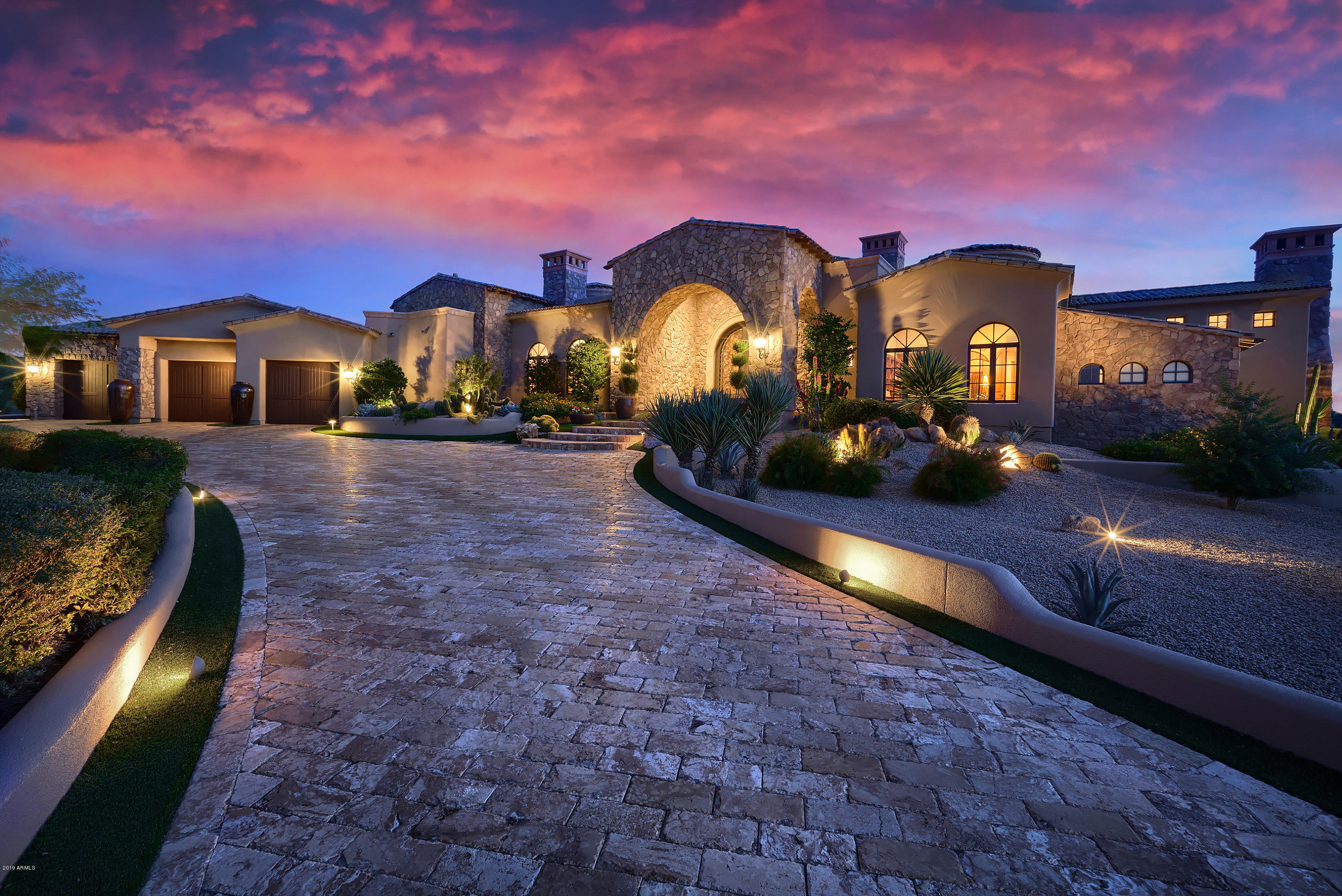 Nestled behind the gates of the prestigious Talus at Troon North golf community, sits this 6,612 sq.ft. estate. Impressive terraced entry gardens and circular drive  greet you as you approach the stunning iron and glass double door. Masterfully designed this 4 bedroom, 5.5 bathroom property is expertly crafted featuring grand living spaces with soaring ceilings and massive wood beams. Architectural elegance awaits in the formal dining room with coffered ceilings and fireplace. Luxurious chef's kitchen with top level appliances including Viking, Wolf ,Subzero & wet bar. Expansive master suite with master bath offers jacuzzi tub with fireplace for extra ambience, 2 bathrooms, a spa like shower with steam room & 2 walk-in closets. Built to the highest standards this home features 7 fireplace theater room, library and temperature controlled wine room. Lush, resort like backyard, perfect for entertaining with outdoor kitchen, large patio, fireplace, sparkling pool with waterfall and fire features.  The guest casita is beautifully crafted with French pocket doors, wood beam ceiligs, massive fireplace, cozy kitchen with Viking appliances, seperate bedroom and bathroom.  4 car garage, natural stone pavers front and back.  Security system.