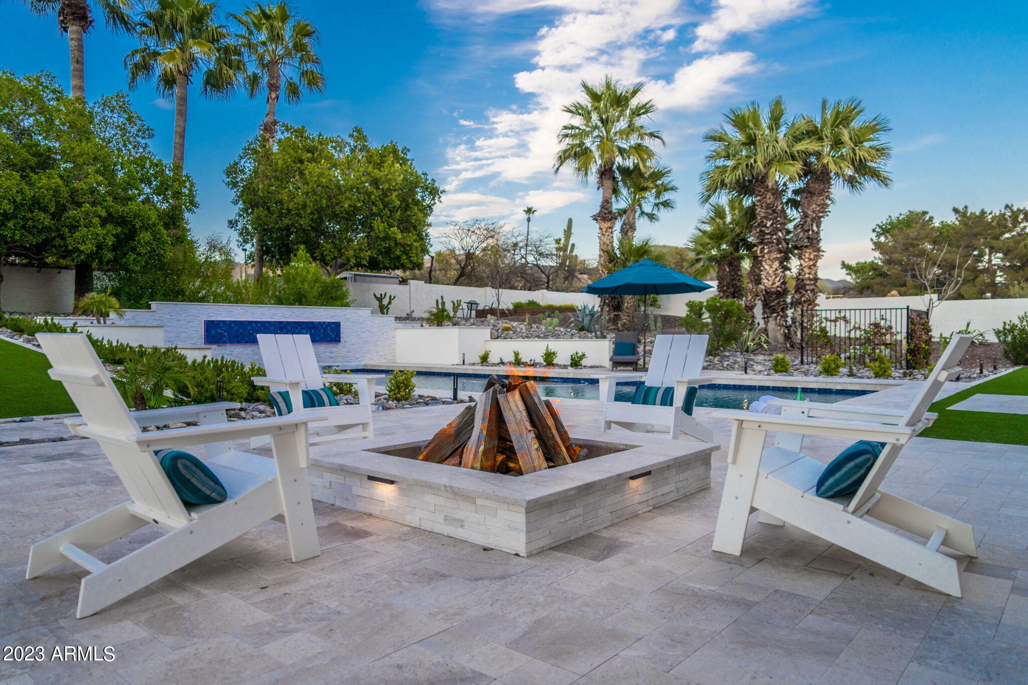 Completely re-imagined inside and out, this thoughtfully renovated Cactus Corridor custom home celebrates crisp, clean lines and a modern European flair. Enjoy a truly special property set on an elevated corner lot with N/S exposure just minutes from shopping, dining & A+ schools. Expansive & flexible living spaces are connected seamlessly using today's favorite finishes & a modern palette with elegant European white oak floors. Living room flows to generous dining space, with adjacent flex room currently used as a sport center. Barn doors could be a perfect option here to enclose this area. Large great room with fireplace provides gathering space for movie night, or open up the French doors to celebrate the stunning back yard views. The fully renovated SubZero-Wolf gourmet kitchen is flawless, offering a modern farmhouse feel with carefully planned work spaces & enjoying the dramatic high ceilings & views to the back yard. One of the two spacious islands is a great place for food prep & casual dining, right next to the European coffee bar & refrigerated wine storage. Split floor plan provides elegant primary retreat with beautifully renovated spa bath & large custom fitted closet. Three additional bedrooms & two full baths complete the east wing. West of the kitchen is an additional en-suite guest space. Step outside to see why this is truly a lifestyle home. The fully renovated back yard features deep covered dining area, extended diving pool with custom tile water feature wall, large turf area for playtime, custom BBQ island with custom shade, elevated garden area, and carefully selected limestone tile for massive entertaining area. The side yard provides RV gate access to the perfectly planned sport court area with pickle ball. Custom accent lighting throughout the exterior of this home provides an unsurpassed setting. Welcome Home!