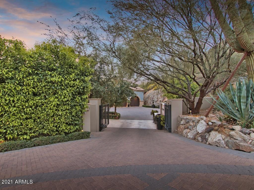 PERCHED HIGH ON THE SOUTH SIDE OF MUMMY MOUNTAIN LIES ONE OF PARADISE VALLEY'S MOST LUXURIOUS RESIDENCES. OFFERING THE MOST UNIQUE INDOOR/OUTDOOR LIVING EXPERIENCE THAT IS TRULY UNRIVALED. NEWLY ENHANCED GAME ROOM, THEATER ROOM AND ADDITIONAL BEDROOM. CUSTOM BUILT IN 2014 WITH A GRACIOUS FLOOR PLAN, HIGH CEILINGS AND OVER 17,000 SF, THIS HIGHLY DESIRABLE ESTATE OFFERS 7 GRAND BEDROOM SUITES, 13 BATHROOMS AND UNMATCHED VIEWS OF CAMELBACK MOUNTAIN AND SPARKLING CITY LIGHTS. AS YOU ARRIVE AT THE GATED RESIDENCE, A LARGE PAVER COURT PROVIDES AMPLE PARKING SPACE FOR YOU AND YOUR GUESTS AS WELL AS A 6-CAR GARAGE. PRIVATELY GATED ESTATE WITH AMPLE PARKING FOR OVER 12 CARS AT ANY TIME. EXQUISITE DETAIL THROUGHOUT THIS TREMENDOUS ESTATE FROM THE MOMENT YOU DRIVE THROUGH THE GATE. FROM THE EXTRAVAGANT CLASSIC EUROPEAN FAÇADE TO THE HAND LAID CHEVRON WOOD FLOORING AND CUSTOM METAL WORK. THROUGH THE ELABORATE GLASS AND IRON FRONT DOORS, INITIALLY STUNNED BY THE SCALE OF THE ROOMS, QUALITY OF FINISHES AND MOUNTAIN VIEW. THE LARGE OPEN PLAN FORMAL LIVING SPACE INCLUDES THE LIVING ROOM, DINING ROOM AND GAME ROOM WITH A FULL BAR. FLOOR PLAN FLOWS INTO THE KITCHEN, FAMILY ROOM AND CASUAL DINING AREA. KITCHEN DELIVERS EXCEPTIONAL CAPACITY TO CATER. HUGE DUAL ISLANDS, THE FINEST APPLIANCES, RARE MARBLE COUNTERTOPS, AN ABUNDANCE OF CABINETRY SPACE, INTRICATE BACKSPLASH WORK AND A FULL BUTLER'S PANTRY. LARGE DOORS FROM THE DINING AREA LEAD YOU TO THE BALCONY WHERE YOU EXPERIENCE THE LUXURY SCALE AND FACILITIES OF A FIVE-STAR HOTEL. STEPS LEAD TO A PATIO WITH A BEAUTIFUL SPA INCLUDING FOUNTAIN FEATURES, A SEATING AREA AND VIEWS SPANNING THE EAST VALLEY TO DOWNTOWN PHOENIX AND THE ICONIC CAMELBACK MOUNTAIN. TAKE A FEW STEPS DOWN TO THE LAWN AREA WHERE YOU'LL FIND AN ABUNDANCE OF SPACE FOR ENTERTAINING AND A LUXURIOUS PRIVATE SWIMMING POOL. AN EXPANSIVE, BRIGHT MASTER SUITE HOSTS A SPA-INSPIRED BATH, HUGE WALK-IN CLOSET WITH ROOM TO DISPLAY YOUR BELONGINGS, SEPARATE HIS AND HERS BATHROOMS, A CHARMING SEATING AREA, FIREPLACE, INCREDIBLE VIEWS AND EXERCISE ROOM. LOWER LEVEL INCLUDES A LARGE WINE CELLAR AND A LAVISH SPACE TO ENTERTAIN GUESTS WITH A PRIVATE ENTRANCE. AS WELL AS TWO BEDROOM SUITES, THEATER ROOM AND HUGE COVERED PATIO. A NEW GENERATION OF HOME WITH TRADEMARK ELEGANT LINES - STRIKING RICHNESS WITH BEAUTIFULLY PROPORTIONED SPACES ABOUND. SEVEN INCREDIBLE FIREPLACES THROUGHOUT THE ESTATE, SELF-CONTAINED GUEST SUITE, FOUR SEPARATE LAUNDRY FACILITIES, ENORMOUS DECKS ON BOTH THE MAIN LEVEL AND THIRD-LEVEL, PERFECT WORK-FROM-HOME OFFICE WITH SEAMLESSLY INTEGRATED INDOOR AND OUTDOOR ENTERTAINING SPACES. THIS DREAM HOME IS YOUR OWN PRIVATE OASIS FOR A NEVER-ENDING VACATION.