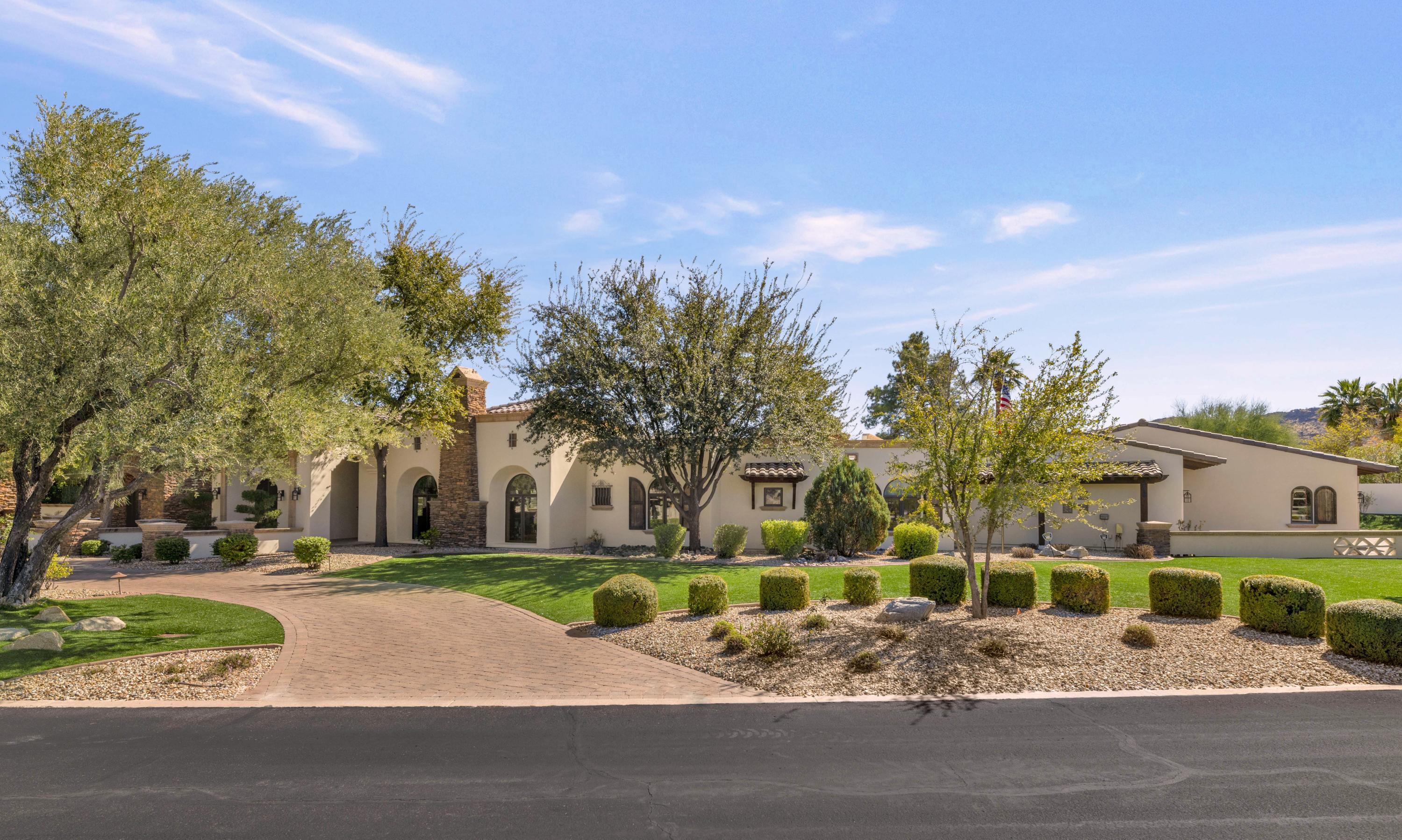 This is a phenomenal estate property and from the moment you arrive, you'll be impressed by the outstanding architectural elements, design quality and unique style. The gracious entry, accented in stone, leads to a home that's built for entertaining. The wide open, sun filled rooms are accentuated by oversized custom doors and windows providing a dramatic backdrop to every space. The billiards room has a restaurant style bar with a beer tap, sink, ice maker, two dual temperature controlled wine refrigerators, two sets of refrigerator drawers, Miele espresso/coffee maker, and a conversation area offering extra seating. The beautiful large scale dining room has a custom coffered ceiling, the island kitchen has a Wolf range with double ovens, Wolf steam oven and warming drawer, ...see more double dishwashers, prep sink, oversized breakfast bar, and plenty of room to prepare and serve simultaneously. The great room is exactly what you'd expect in a home of this caliber, the gym is another great space, and the master suite is an absolute showpiece with its own washer and dryer, and an impressive closet and master bath that are both simply outstanding. All of the secondary bedrooms and bathrooms are perfect, and there's a charming relaxation room for when you want to settle in and unwind. Iron accents, outstanding millwork, five fireplaces, cantera stone, wood flooring, exposed wood beams, custom ceiling detail, and top of the line tile and granite are just a sample of the great taste you'll be treated to in this sprawling residence. The full guest house is perfect for weekend visitors, yet fully dialed in for a long term stay with its own kitchen and laundry room, and the grounds are absolutely exquisite with a heated pool and spa, water features, putting green, outdoor living room, multiple patios, and a huge yard. To top it off, the air conditioned five plus car garage is any auto enthusiast's dream. This is a very special home located in a very special neighborhood ready for the next family to begin creating memories of their own!