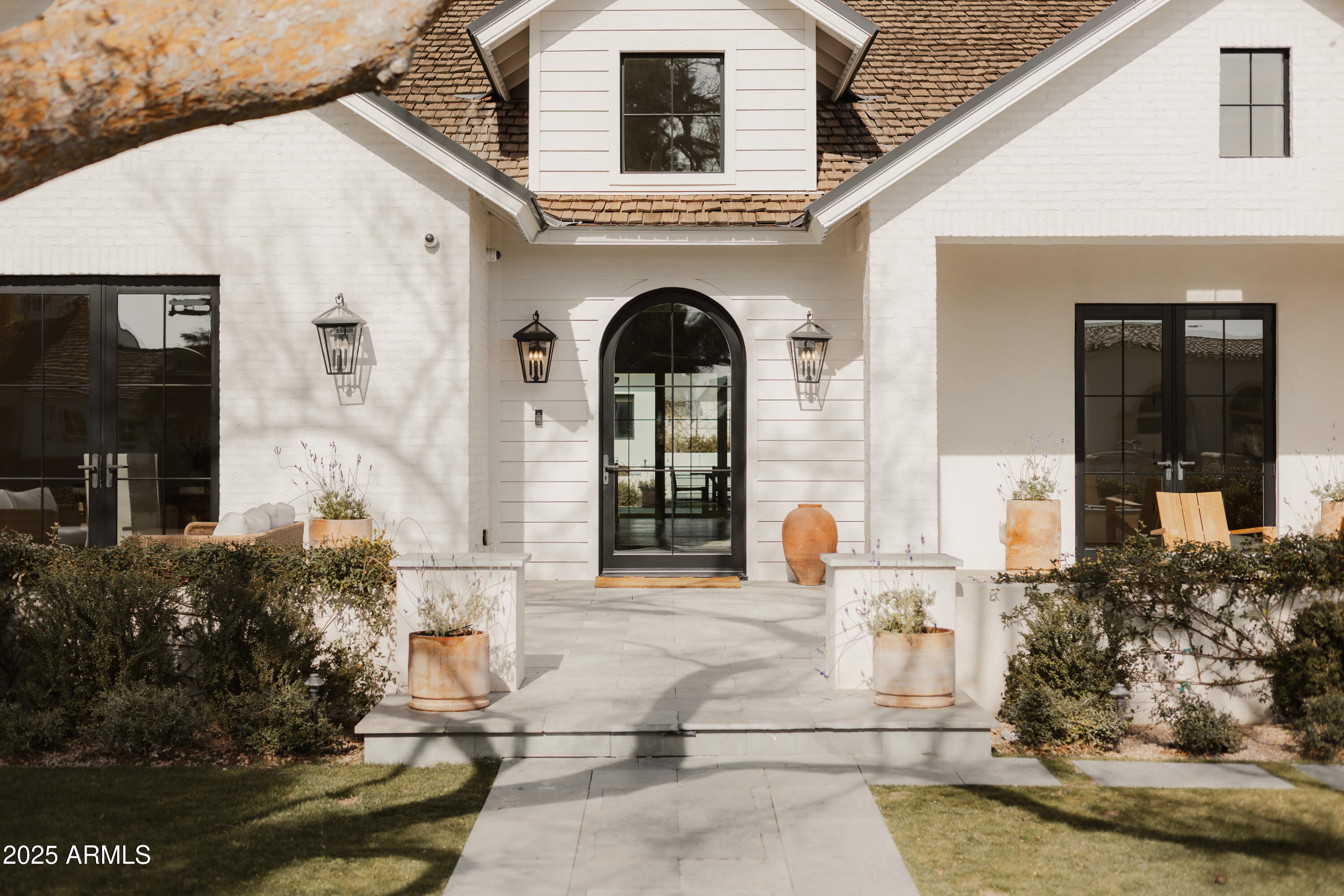 This custom Arcadia estate sits on a .8-acre lot with breathtaking Camelback Mountain views. Remodeled by Mcintyre Development and turnkey with 5 bedrooms, 5.5 bathrooms, a guest house, office, media room, and exercise room. The two-story home showcases wood flooring, high ceilings, gas fireplaces, and natural light from French windows and doors. The chef's kitchen boasts high-end appliances, gold finishes, a Butler's pantry with multiple ovens, and a large island. The primary suite offers a private backyard entry, gas fireplace, dual vanities, soaking tub, oversized shower, and walk-in closet. The backyard is perfect for entertaining, with a guest house, custom pool and spa, covered patio with built-in BBQ, and a grass yard with citrus trees. Enjoy biking or walking along the canal, and be minutes away from Phoenix's top resorts, golf courses, hiking, dining, and shopping.