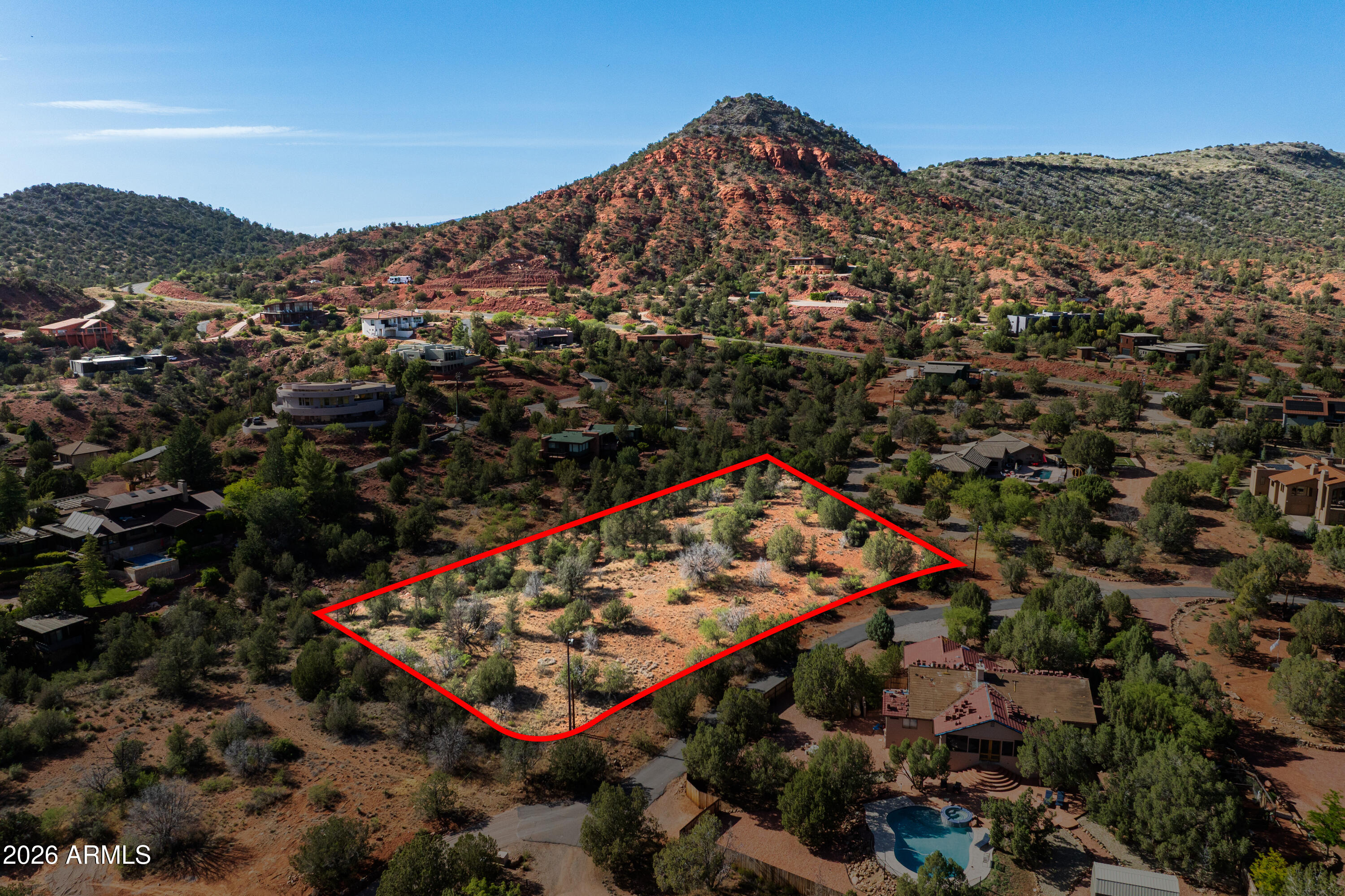 Discover a rare opportunity to own one of the last vacant lots on the street in Sedona's highly desirable Cup of Gold Estates. Spanning approximately 1.34 acres, this level parcel offers an exceptional setting to build your dream home with no HOA restrictions. Located on the peaceful nature park side of West Sedona, the property combines privacy, usability, and direct access to some of the area's best outdoor recreation. Cup of Gold property owners enjoy community access to Oak Creek through a designated neighborhood parcel, where scenic creekside paths, shaded natural areas, and boulder formations, create a truly special private Sedona experience. The property is also just moments from multiple trails Red Rock State Park, and miles of surrounding National Forest with endless opportunities for hiking, biking, horseback riding, and off road adventures.
Enjoy a quieter side of Sedona away from the traffic and crowds while still being only a short drive to the restaurants, grocery stores, and conveniences of West Sedona. The area is known for its dark skies, peaceful atmosphere, and abundant wildlife, with deer, hummingbirds, and hot air balloons often part of the daily scenery. A rare chance to build in one of Sedona's hidden gem neighborhoods surrounded by nature and outdoor adventure.