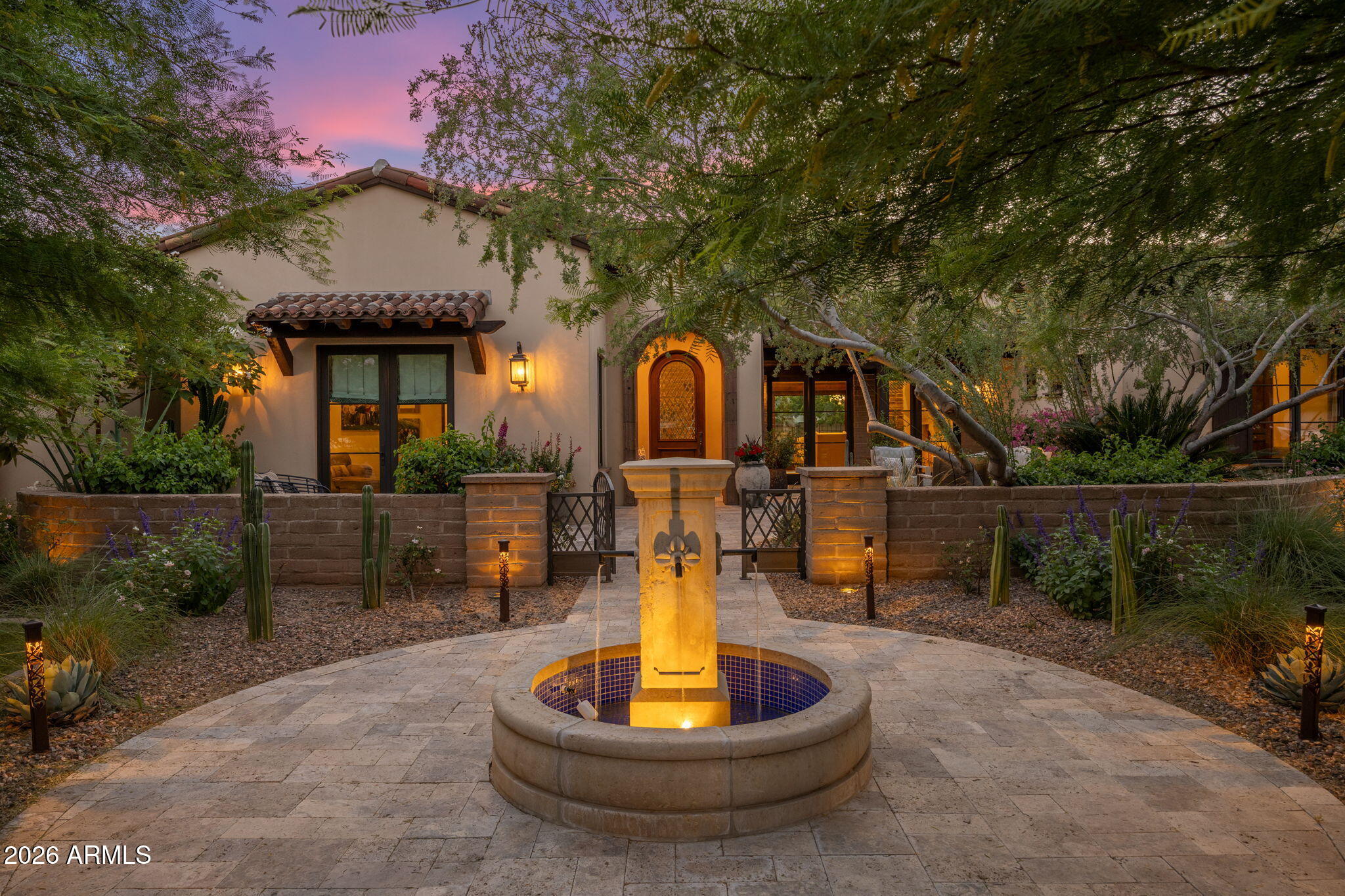 A rare opportunity in the heart of North Central Phoenix, this custom estate blends timeless architecture with exceptional craftsmanship and modern livability. Built in 2016, the home offers 6,431 sq ft with six en-suite bedrooms, 6.5 baths, and a private office--designed for both everyday living and elevated entertaining. A cantera stone entry leads to 16' vaulted ceilings, exposed beams, clerestory windows, and handcrafted adobe detailing. The chef's kitchen features dual islands, Viking appliances, Sub-Zero refrigeration, and custom cabinetry. A full walkout basement includes a bar, media space, guest suite, and access to a terraced patio. Resort-style grounds showcase a negative-edge pool, spa, and multiple outdoor living areas. No HOA, prime location near the Murphy Bridle Path. Features & Upgrades

A truly exceptional custom estate set on approximately one-half acre in the heart of North Central Phoenix. Built in 2016 with a focus on craftsmanship, scale, and timeless design, this residence offers approximately 6,431 square feet, six en-suite bedrooms, and a private office--thoughtfully designed for both refined everyday living and elevated entertaining.

Architectural & Design Highlights
Striking cantera stone arched entry with custom iron doors
Private front courtyard with fountain and mature landscaping
Groin (groined) ceilings and barrel-vaulted architectural details creating depth, character, and a sense of timeless European influence
16-foot vaulted ceilings with exposed solid wood beams
Clerestory windows providing abundant natural light
Handcrafted adobe-style brick accents and custom plaster finishes
Wide-plank hardwood flooring throughout main living areas
Disappearing wall of glass seamlessly connecting indoor and outdoor living
Kitchen & Living Spaces
Chef's kitchen designed for both function and entertaining
Premium appliance package including professional-grade range and built-in refrigeration
Oversized island with seating and custom cabinetry
Quartz countertops with designer finishes
Open-concept great room with fireplace and architectural ceiling detail
Formal dining space ideal for hosting
Primary Suite & Bedrooms
Private primary retreat with serene views of the backyard
Spa-inspired primary bath with soaking tub, walk-in shower, and dual vanities
Expansive custom walk-in closet
Six en-suite bedrooms offering privacy and flexibility for guests or multigenerational living
Dedicated office space ideal for remote work or study
Walkout Basement & Entertaining
Fully finished walkout basement designed for entertainment
Custom bar and lounge area
Multiple media zones with surround sound capability
Full wall of glass doors opening to a lower-level patio
Ideal for game days, gatherings, or private guest quarters
Outdoor Living & Resort-Style Amenities
Professionally designed, terraced backyard maximizing the unique basement configuration
Resort-style negative-edge pool with cascading spa and integrated water features
Custom water slide creating a one-of-a-kind outdoor experience
Multiple seating and entertaining areas
Outdoor fireplace and lush landscaping
Seamless indoor/outdoor flow designed for the Arizona lifestyle
Guest Accommodations
Private guest wing with separate entrance
Dedicated garage space for guest or extended family use
Ideal for long-term guests, multigenerational living, or private quarters
Additional Features
Smart home technology and integrated systems
Custom lighting and designer fixtures throughout
Energy-efficient construction and modern mechanical systems
Oversized lot offering privacy and space rarely found in this location
Location

Situated in one of North Central Phoenix's most desirable neighborhoods, known for its tree-lined streets, iconic Murphy Bridle Path, and proximity to top-rated schools, dining, and everyday conveniences. This location offers a rare combination of privacy, accessibility, and enduring value.