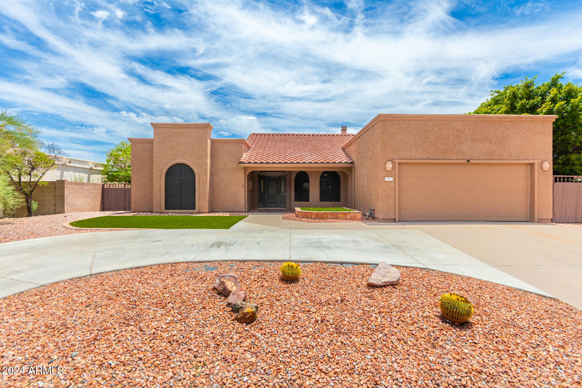 Wow!  What a beautiful & large updated Ahwatukee single level! Notice the circular driveway & 2 RV gates in addition to 2 car garage.  Walking up to refinished front door you will see tile patio.  Inside soaring ceilings, oversized living & dining room with tile, fireplace & lighting.  Updated kitchen with white painted cabinets, stainless steel appliances & pantry opens to family room with fireplace & access to back patio.  You will love the large bedrooms.  Primary bedroom has separate entry to backyard, large bath with separate shower/tub.  Secondary bedroom also has access to its own bath.  Garage set up with cabinets, epoxy floor & its own exit to backyard. Front & back landscape is beautiful & low maintenance with artificial grass. New carpet and paint in July of 2026.