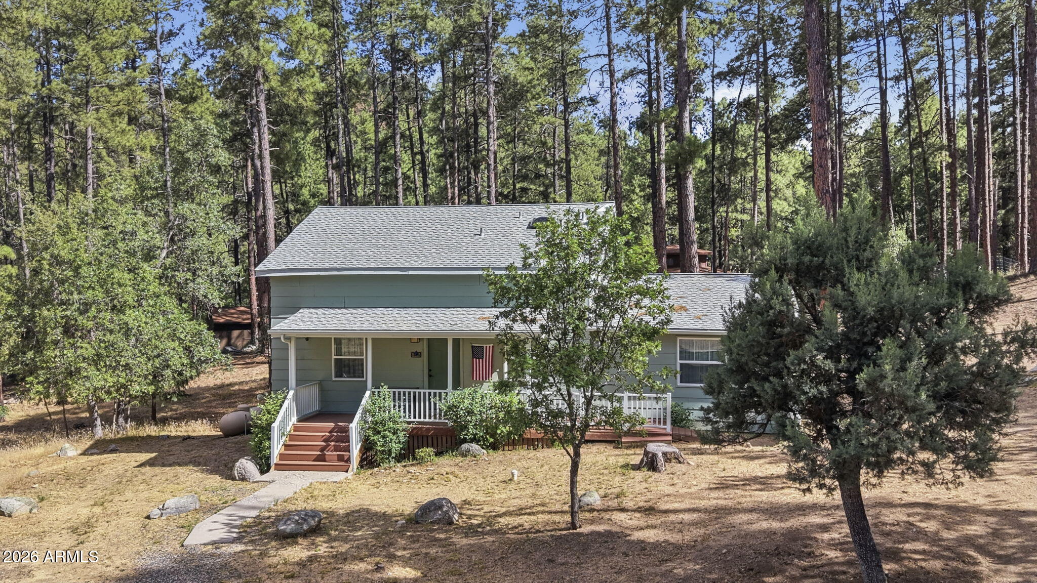 Welcome to your Prescott retreat in the pines. Set on 1.30 acres in a quiet, small neighborhood near the National Forest, this beautifully remodeled 1,720 sq. ft. home offers 2 bedrooms, 2 baths, plus a loft bedroom. Inside, the home blends rustic character with high-quality modern updates, including hickory floors, wood-beam accents, vaulted ceilings, and a stunning stone fireplace that anchors the great room. The remodeled kitchen is both warm and functional, featuring quartz countertops, soft-close maple cabinetry, a large island, a stone backsplash, and updated finishes. The bathrooms have also been tastefully updated with tile showers and newer vanities. Outside, enjoy composite decking, tall pines, natural surroundings, and room to spread out. With paved road access, great for hiking horse privileges and trails, and a location just a short distance from downtown Prescott, this property offers the privacy of mountain living without giving up everyday convenience.