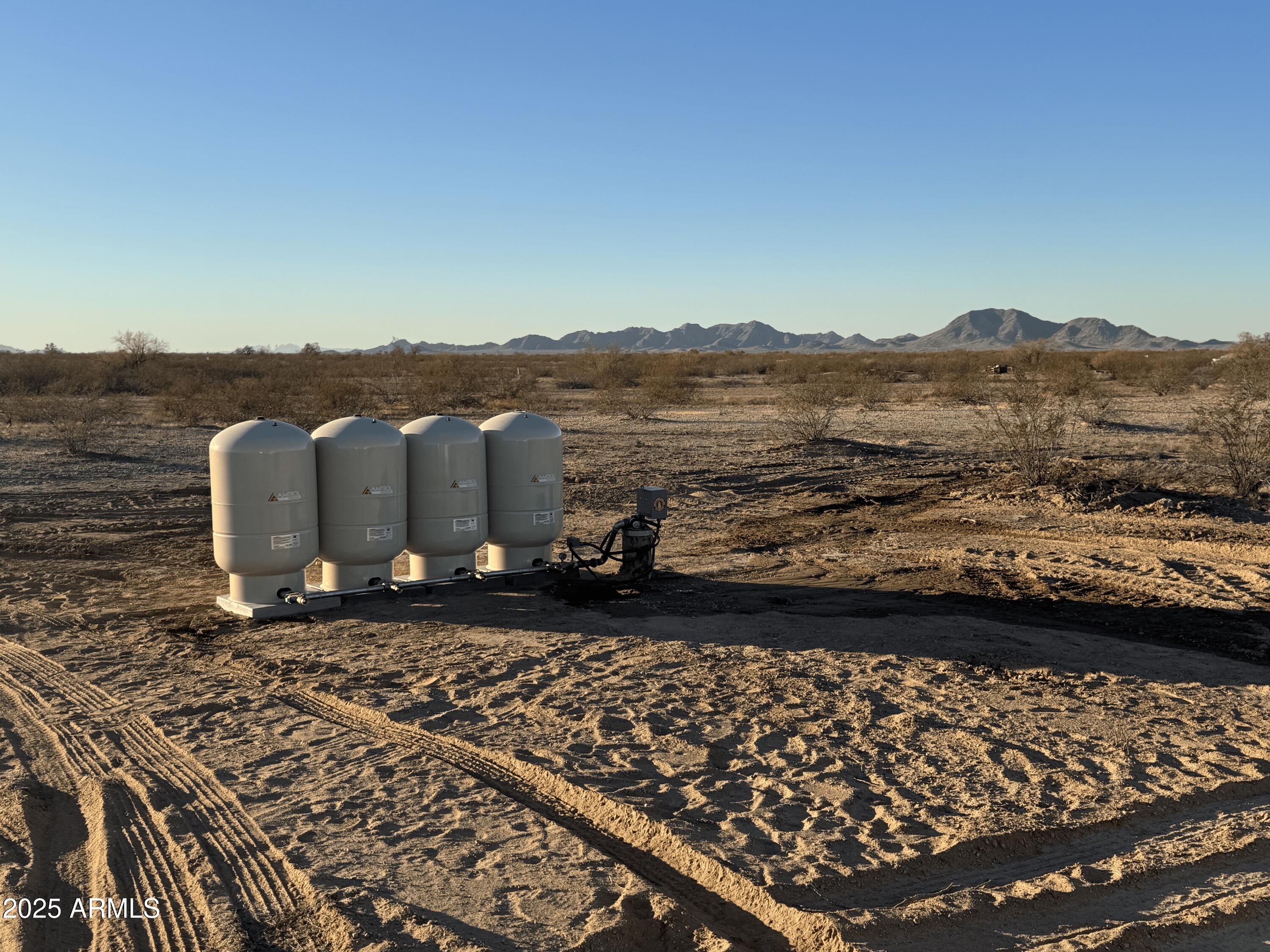 APPRX CENTER OF PARCEL HERE 33.242346, -112.468139   ENTER FROM ALAMO RD, NOT MANZANILLA.  DISCOUNTED PRICING ON THREE 1+ ACRE LOTS READY FOR HOMES!  BRAND NEW STEEL CASED WELL WITH PUMPING SYSTEM INSTALLED. ONLY 4 ON THE WELL.  ELECTRICITY NEAR THE NE PROPERTY CORNER. GRAVELED ROAD FROM ALAMO RD TO THE PROPERTY CORNER.  LEVEL LAND.  NO FLOOD ZONE. POPULAR LOCATION IN RANBOW VALLEY RANCH 2, IN UNINCORPORATED MARICOPA COUNTY WITH BUCKEYE ADDRESS.  SITE-BUILT AND MANUFACTURED HOMES OK HERE. OUTSTANDING MOUNTAIN VIEWS. AREA NEAR FUTURE 303 LOOP, I-11 AND THE SOUTHTERN PART OF ESTRELLA MOUNTAIN RANCH.  SELLER WILL CARRY. REACH OUT FOR CARRYBACK TERMS. DON'T MISS THIS GREAT OPPORTUNITY BEFORE IT'S GONE.  PARCELS C, D & E OF THE SURVEY.