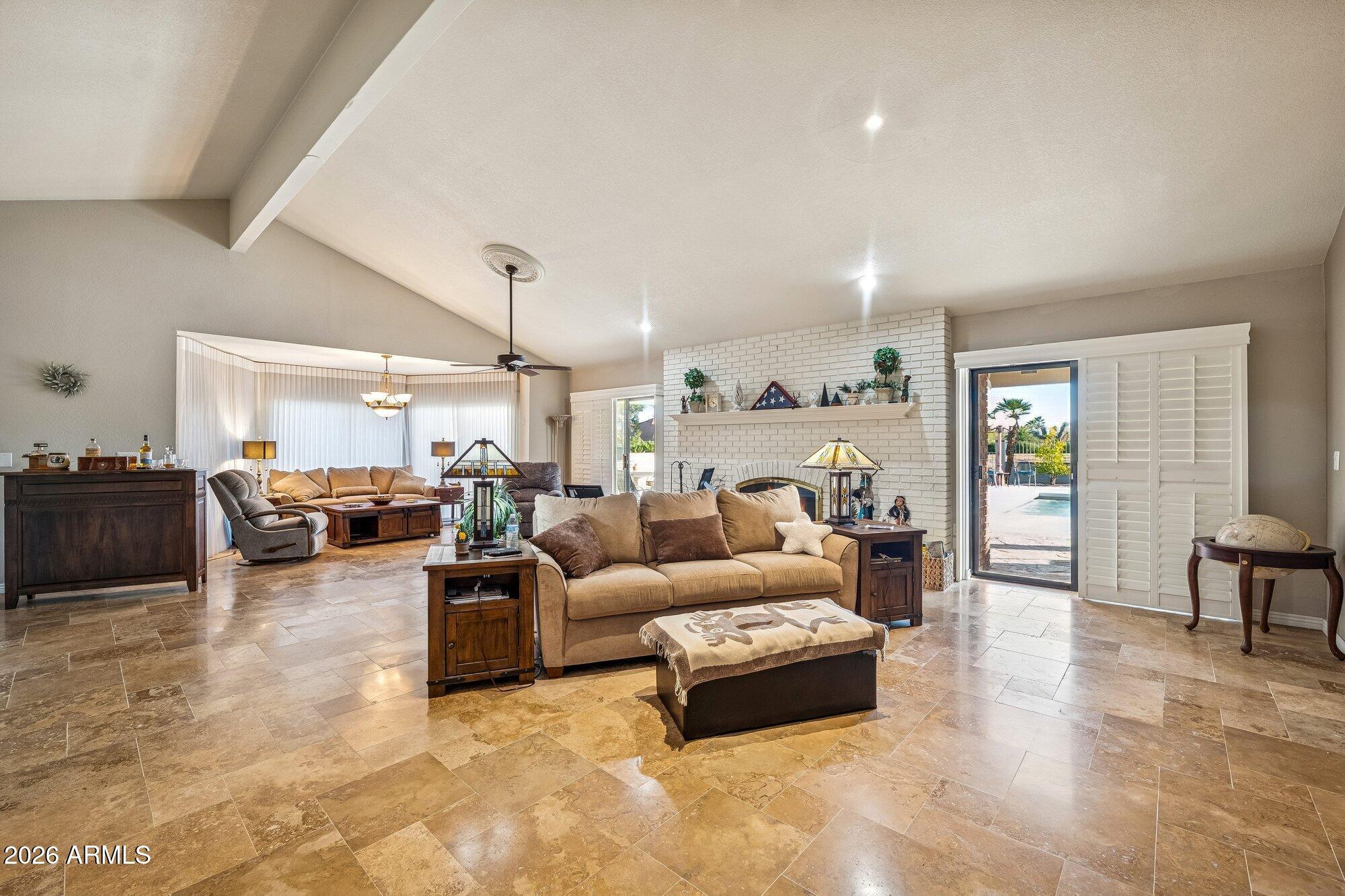 Tucked just off the 15th tee of Quail Run Golf Course, this exceptional home sits on a coveted 1/2 acre corner lot with sweeping mountain views and seamless indoor-outdoor living. Vaulted ceilings and sun-filled spaces flow into the kitchen with skylights and butler's pantry. The private primary suite offers a fireplace and direct backyard access. Outside, enjoy a heated pool, covered patios, ramada, and fire features designed for relaxing or entertaining. Oversized 2.5-car garage fits 2 cars plus a golf cart or extra storage. Refined desert living in a peaceful, upscale 55+ community.