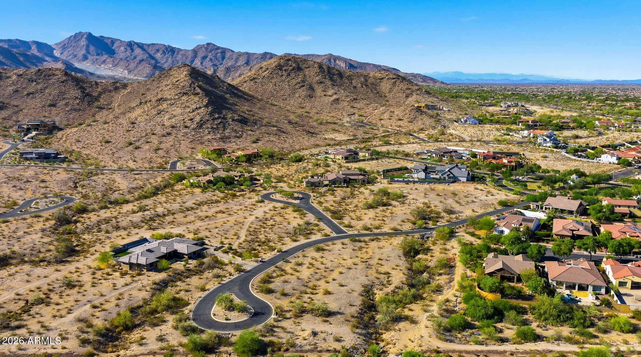 Exceptional 1.34-acre custom homesite in the coveted Mountain Coves Enclave of Verrado, featuring one of the largest building envelopes in the community. Privately positioned within a quiet cul-de-sac, this premium lot showcases breathtaking panoramic views of the White Tank Mountains, vibrant Arizona sunsets, and an unmatched sense of privacy and tranquility. Surrounded by the natural beauty of the Sonoran Desert, the expansive homesite offers the perfect canvas to design and build a one-of-a-kind luxury residence with ample space for resort-style outdoor living, pools, guest casitas, courtyards, and expansive entertaining areas. Ideally located near Verrado's premier amenities including championship golf, community pools, parks, fitness centers, top-rated schools, shopping, dining, and miles of scenic hiking and biking trails. A rare opportunity to secure one of the finest remaining custom homesites in one of Arizona's most sought-after master-planned communities.