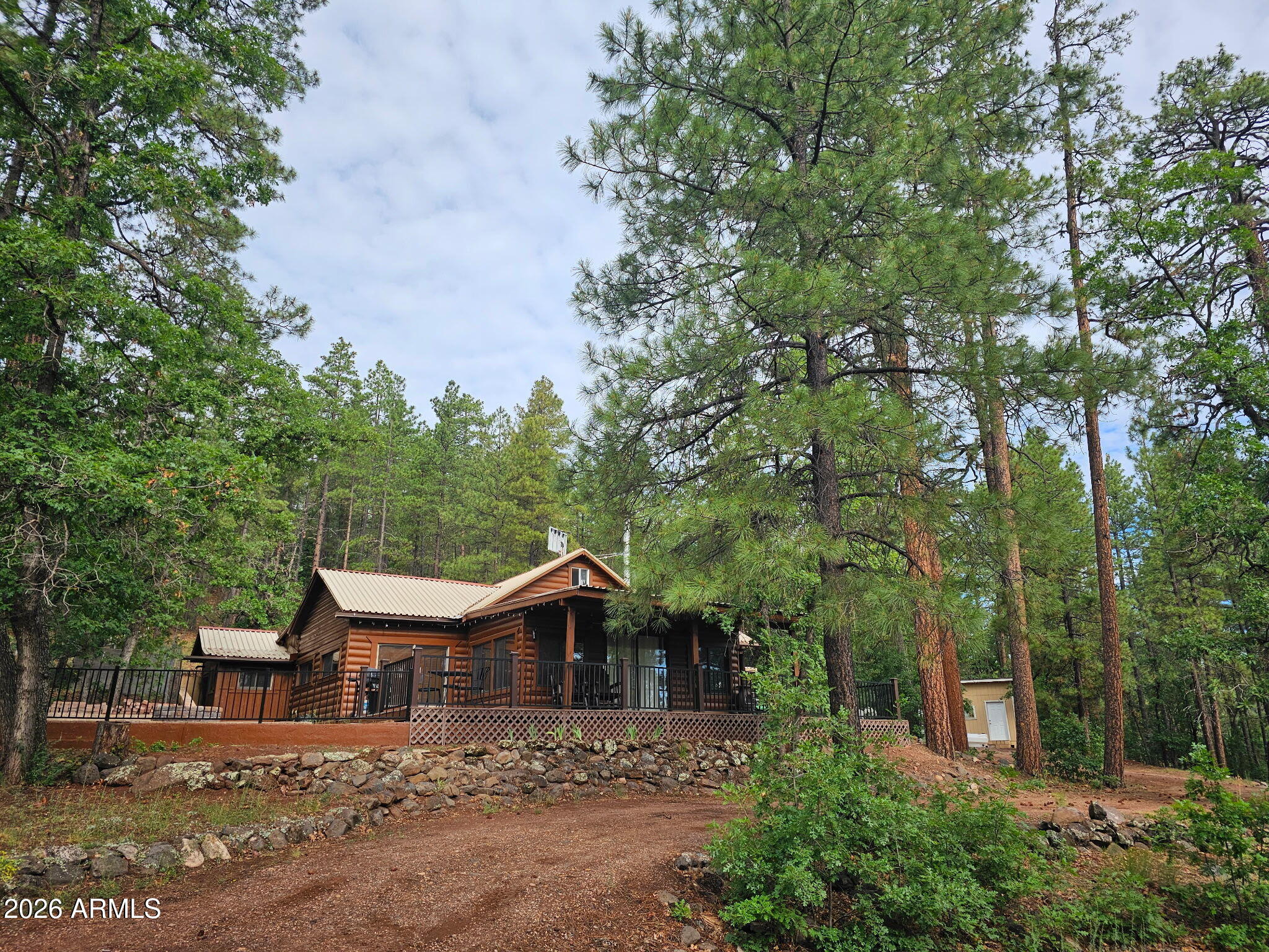 Beautifully remodeled 1,440 sq ft, 2-bed,1 bath off-grid cabin on 1.21 acres in Clear Creek Pines, Unit 1, located Elk Hunt Unit 5. Features a stone wood-burning fireplace with propane heaters as an alternate heat source, wrap-around deck, fire pit, storage shed, and ample RV parking. Powered by solar with a 1,000- gallon water tank and shared well for hauled water. Approximately 200 yards to National Forest and a short ATV ride to Happy Jack Lodge.