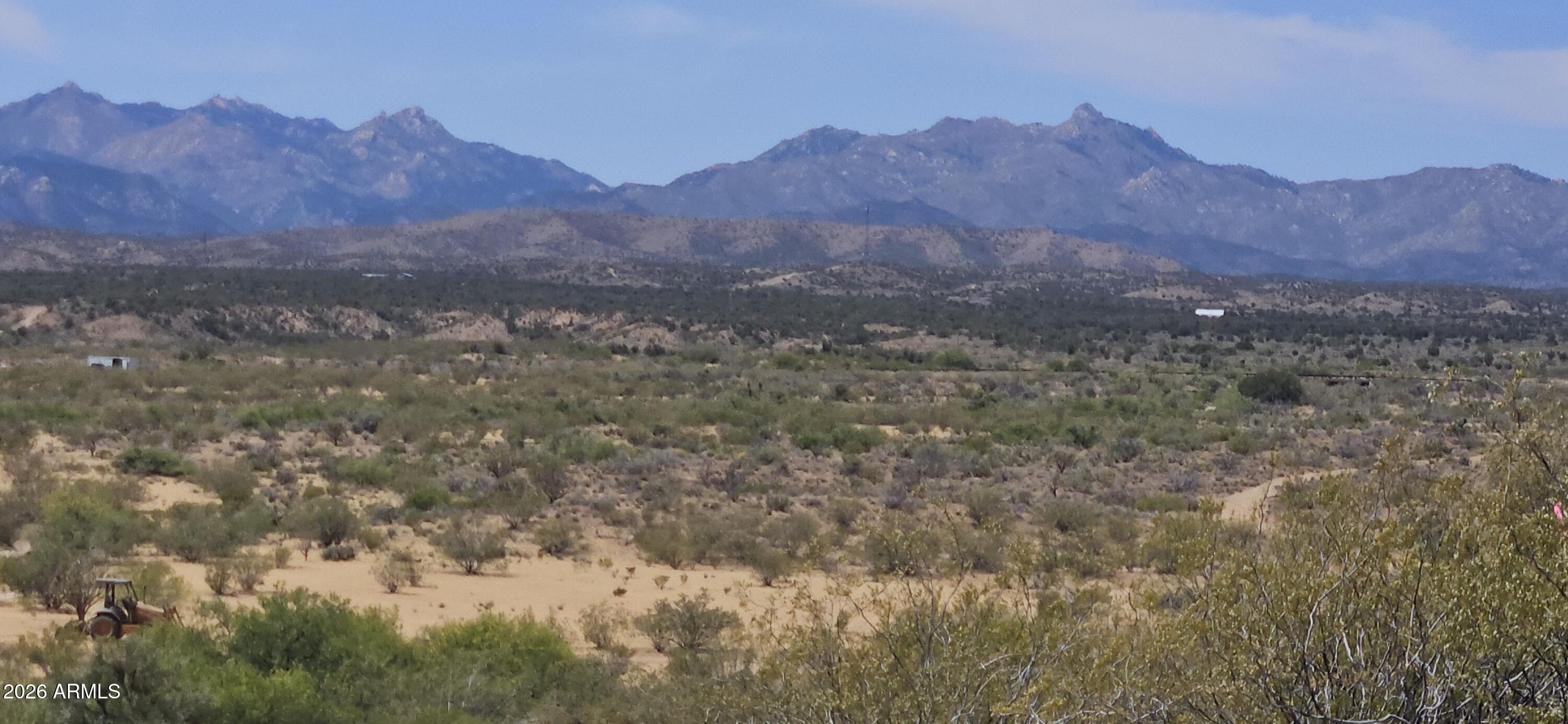 Great opportunity for RV park near the busy Hwy 93, south of I-40. Property backs to state land! This 36.57 (thirty six point five seven two) acre parcel currently zoned agricultural-residential. Over 2300 feet feet deep. Access off of  Silverado Parkway, (approximately 100 feet wide). The parcel is generally level with seasonally active washes entering on the northwest corner.  Power lines approximately  1 mile. Survey recently recorded in 2025-024355. Parcel 21F-3.  Seller may carry with good down payment.  Great views, a few trees, nice ridgeline for elevated building area and unlimited potential. Potential to combine with another 37 acre parcel to the south.