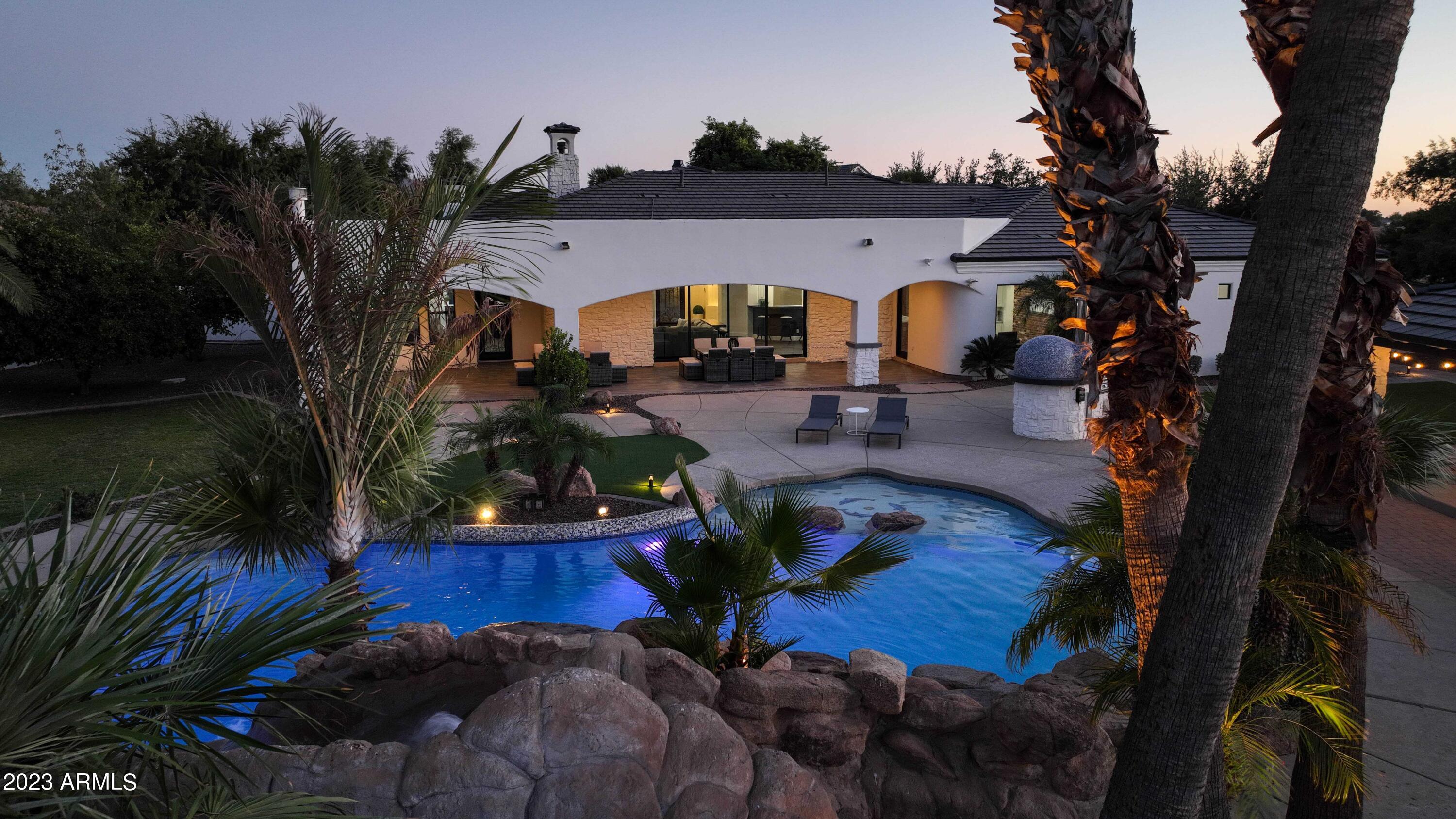 This magnificent luxury estate, set on a spacious ¾-acre cul-de-sac lot within the highly coveted community of ''Circle G at Ocotillo'' in Gilbert, is a true masterpiece. Recently renovated from top to bottom, including the detached casita, it exudes the feeling of a brand-new construction. With an abundance of natural light and an open floorplan that boasts generously sized living areas, this home offers a seamless connection between the exquisitely appointed interior and the resort-style outdoor oasis.

As you enter, you'll be greeted by a full wall of sliding glass that seamlessly integrates the indoor space with the outdoor paradise. The exterior is thoughtfully designed, featuring an outdoor kitchen, pizza oven, detached casita, storage shed, a vast covered patio with a fireplace and fire features, and an impressive custom-built pool adorned with natural stone waterfalls and multiple water features.
The detached casita is a standalone gem, complete with a full kitchen, a cozy living room, a separate bedroom with a walk-in closet, and a full bathroom. Inside the main residence, you'll find a smartly designed layout with an open, split floorplan, a private office with a separate entrance, a formal dining room, and an expansive kitchen and living room combination.
The owner's retreat is a sanctuary of luxury, offering tranquil backyard views, a professionally designed walk-in closet, and an enormous, fully renovated bathroom. The bathroom is equipped with his and her sinks, a spacious walk-in shower with rainfall showerheads, a freestanding bathtub, and even a convenient coffee bar.
This estate's curb appeal is unparalleled, with a private, gated entrance leading to a grand portico and a stunning front courtyard adjacent to a circular driveway. From the moment you set foot on this remarkable estate, you'll immediately feel the warmth and comfort of home.