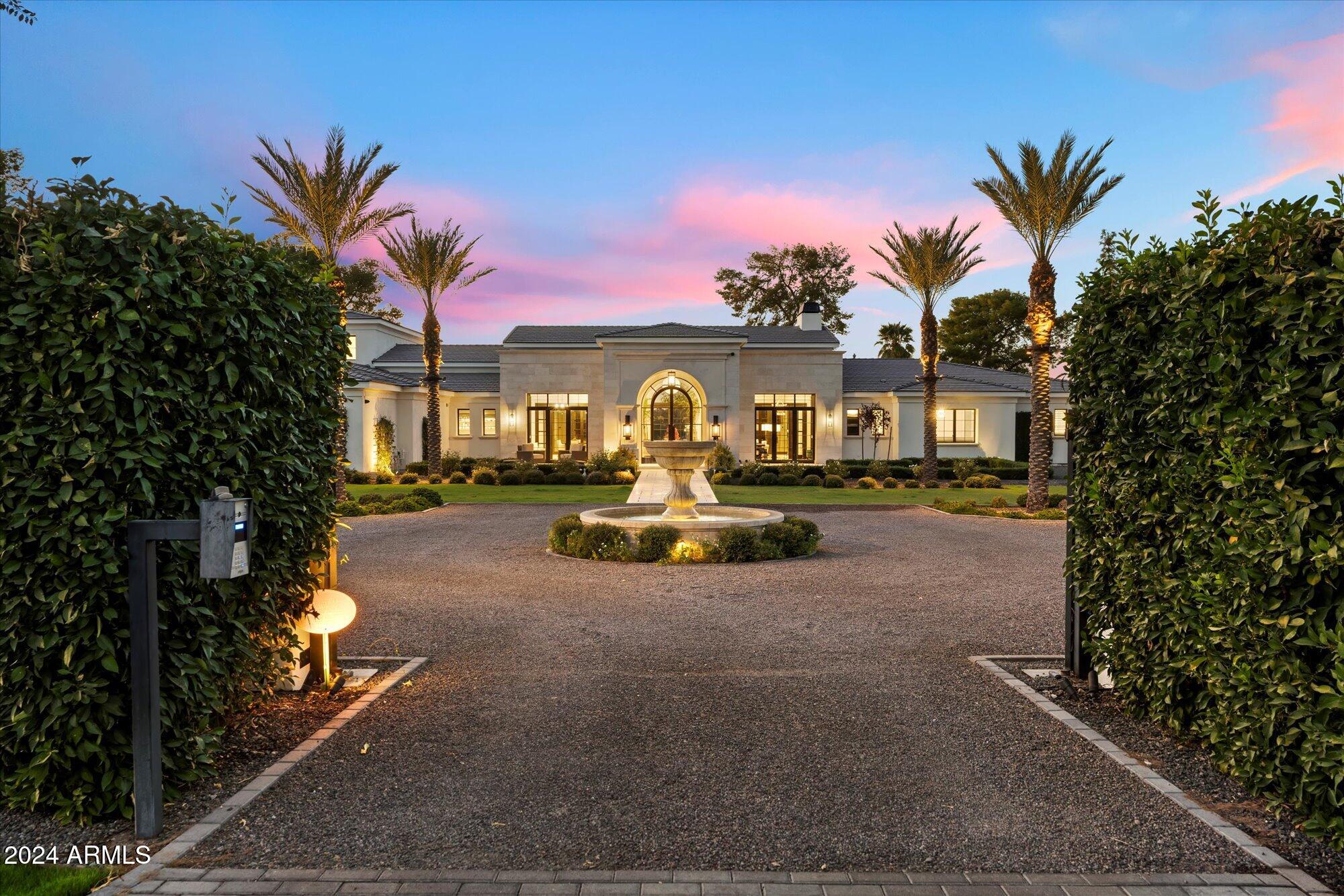 Experience luxury living with this remarkable estate featuring a five-car garage and a charming guest casita, all crafted by the esteemed DeCesare Group. Set against the backdrop of the legendary Arizona Biltmore Circle, this property spans 1.23 acres and boasts breathtaking, unobstructed views of the Estates Course. Entering through the lush landscaping and private gate, you'll find a motor court leading to an inviting front entrance. Inside, you're greeted by expansive golf course vistas, soaring ceilings, and exquisite coffered wood detailing, complemented by stylish herringbone oak flooring throughout. The main residence encompasses 5,629 square feet, offering a spacious layout that includes three bedrooms, two bonus rooms, and 3.5 bathrooms, all conveniently situated on one level... . Outside, multiple patios provide perfect spots to take in the panoramic scenery, while the saltwater pool and spa add a luxurious touch to the backyard. Additionally, a 952-square-foot guest casita offers a living room, bedroom, and versatile space, making this an exceptional opportunity in the Biltmore area!