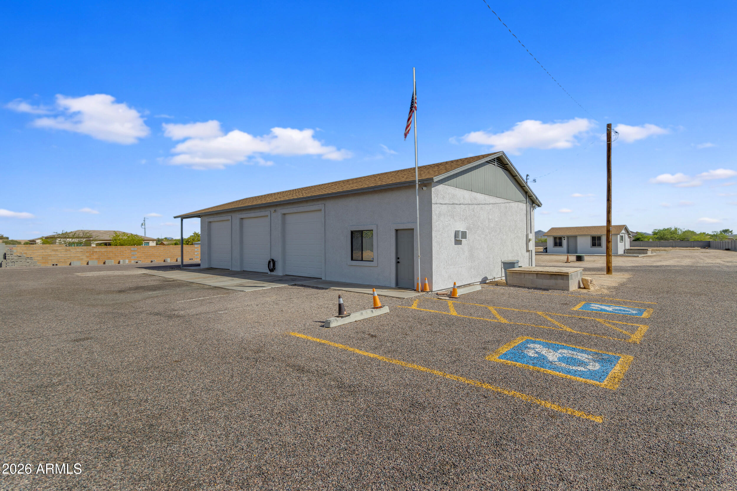 Rare opportunity for homeowners, investors, or business owners on 2.29 acres in the growing City of Goodyear. This versatile property offers a unique blend of ranch style living, income potential, and future development potential. With frontage road access, private paved and gravel driveways, and flexible zoning possibilities, the property can remain residential, potentially be split (buyer to verify), or held as a long-term investment in a rapidly expanding area. The standout feature is an impressive 2,100 sq ft detached shop with its own electric meter, fully equipped with 220 power, a car lift, three front garage bay doors, and one rear bay door. The property also includes garage space with capacity for up to 6 vehicles, a covered RV slab with hookups, a private office, and a half bath. Surrounded by open space and offering room to create a resort-style backyard, this property provides a rare combination of privacy, functionality, and long-term opportunity--making it ideal for collectors, entrepreneurs, or a live/work setup (buyer to verify).

The 3-bedroom, 3-bath home plus den/flex space offers comfortable and functional living, featuring tile flooring throughout, an updated electrical panel, private well water, flood irrigation, citrus trees, and a fenced yard. The flexible layout provides endless possibilities, whether for a home office, gym, or creative space.

The primary suite serves as a private retreat with direct backyard access, a walk-in closet, and an en-suite bath. A secondary bedroom includes its own en-suite bathroom, ideal for guests, along with an additional bedroom and full bath for added convenience. Designed for those who value space and versatility, the property also includes an attached 2-car garage. A detached casita adds even more flexibility for multi-generational living, guest quarters, or a private studio.