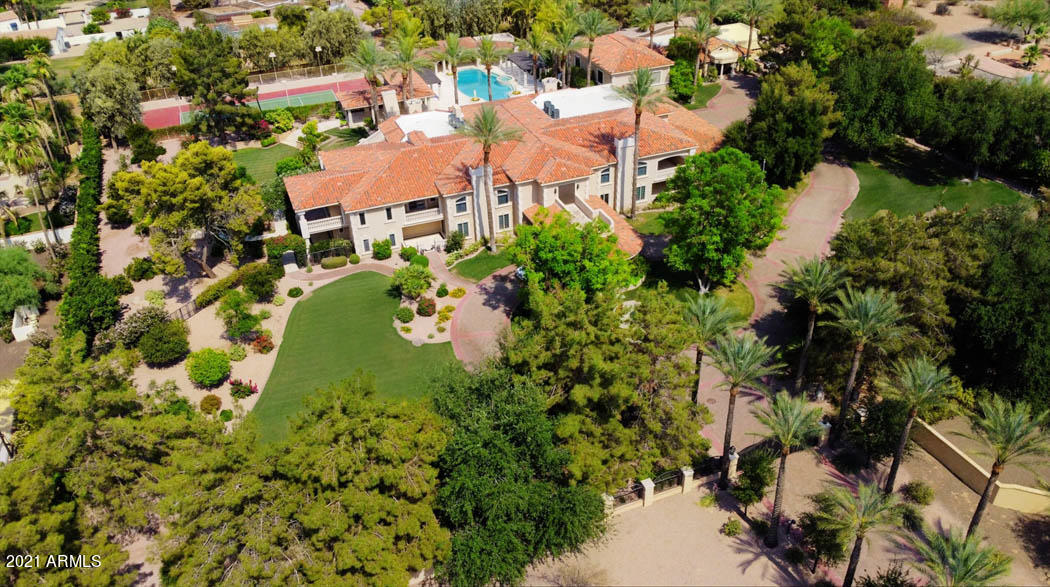 One-of-a kind Private walled and gated Estate in the center of Paradise Valley not far from the new Ritz Carlton.   LOVE the home or CREATE YOUR DREAM ESTATE on this SPECTACULAR 3.25 acre lot.  Interior and exterior painting completed now. Renovated in 2012 (by previous owners) with well made custom cabinetry, marble flooring, and high end appliances/fixtures.  Estate includes a  newer 2bed/2bath Guest House,  FULL-SIZE INDOOR BASKETBALL Court, Lighted Tennis Court, Swimming Pool+Spa, Vegetable garden, Citrus grove, Home Theater, Wine Cellar, garage parking for 8 + MORE. Mountain Views and Immaculate mature landscaping with custom fountains + a private well to water the grounds!  Very rare with 2 gated entries to the estate.  Possibility to split lot.   Don't miss this unique opportunity.