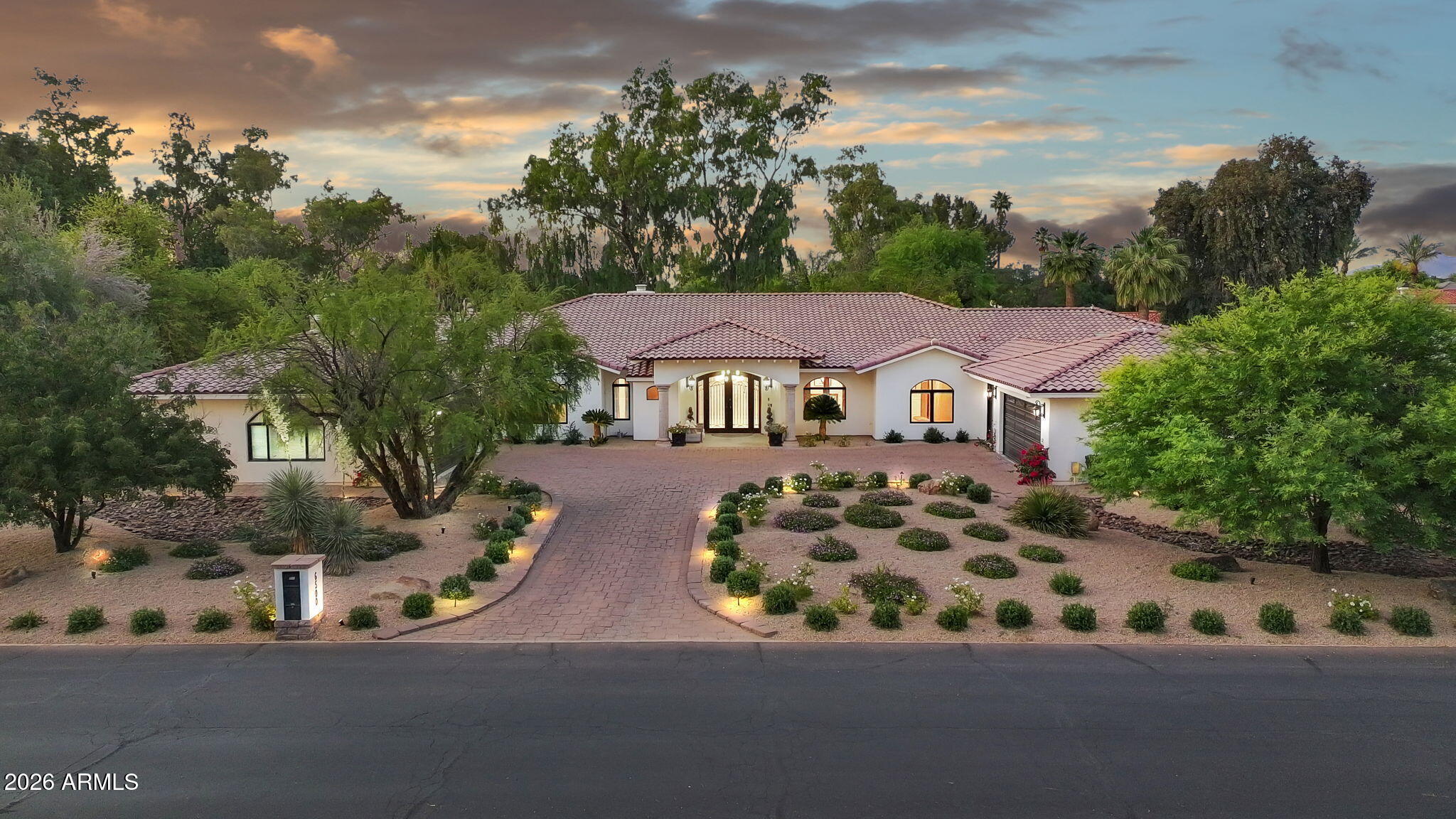 Step inside this timeless Paradise Valley estate and let the details speak for themselves. Soaring ceilings greet you in the entry. Cove lighting warms the formal dining area at dusk. Black granite wraps the fireplace and entry details, grounding the spaces in something quietly architectural. A study in thoughtful renovation, this remodeled residence is defined by quality materials and craftsmanship. Expansive living areas are designed as a series of distinct spaces, each one purpose-built for living well and entertaining beautifully.
The kitchen is the centerpiece of the home, featuring custom cabinetry, Wolf, Subzero, and Viking Appliances surrounded by double islands topped with marble and a cove ogee edge detail.  Mirrored paneled appliances disappear into the kitchen design, and dedicated back kitchen and pantry area allow you to hide the necessities while the kitchen remains the showpiece. 
The large primary suite features its own sitting area and French doors that open to the covered patio, a perfect place for that morning coffee.  The luxurious bathroom has two vanities, a soaking tub, and an oversized shower.  The primary closet is wrapped in rich custom cabinetry, giving it a high-end retail feel, and includes a stackable washer and dryer.  Three additional en suite bedrooms round out the main home.  An attached casita features a living and dining area with a full kitchen and a separate bedroom suite.  The exterior entrance makes this casita a fantastic option for multi-generational living, overflow guests, or income-producing opportunities.  The resort-style backyard with a sparkling pool features smart irrigation and a full outdoor entertainment setup with ample green spaces. A six-car garage and dedicated RV parking make this a rare offering for collectors and enthusiasts. Located minutes from upscale dining, shopping, and Sky Harbor Airport, this is a turn-key estate where nothing has been left to chance. Unique in style. Thoughtfully redeveloped, designed for living well and at under $700 a square foot, an INCREDIBLE value in Paradise Valley.