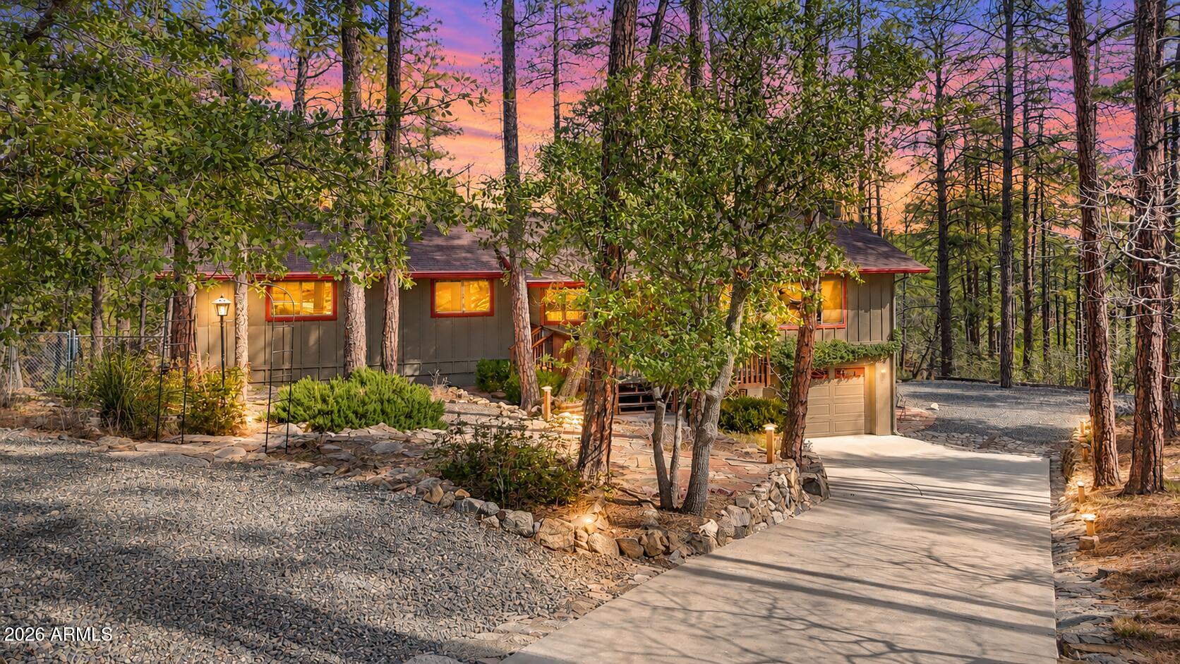 Set on a rare 1.4 acre Ponderosa Pine covered lot with a seasonal creek in the highly sought-after Highland Pines community, this property feels like a private escape, yet remains just minutes from downtown Prescott. With hiking, biking, and ATV trails right outside your door, adventure and tranquility coexist!

Inside, timeless mountain architecture shines with expansive tongue-and-groove ceilings, warm wood flooring, and a striking stone fireplace anchoring the great room. Walls of windows frame peaceful forest views and flood the home with natural light, creating seamless indoor-outdoor living. In addition to the 4-bedrooms, this home features a flexible living space downstairs, that is currently used as a rec room but could be ideal for guests, a home office, or creative pursuits. A detached outbuilding - originally an oversized two-car garage -offers amazing potential as a guest house, home office, yoga studio, rental opportunity, or workshop, adding flexibility, future value, and possible income. RV parking further expands the property's functionality.

Enjoy covered front and back decks designed for year-round outdoor living, from crisp mornings to cool summer evenings. Offering privacy, usable acreage, and a true retreat-like setting, this is a rare opportunity for a full-time residence or part-time escape in one of Prescott's most treasured mountain communities.