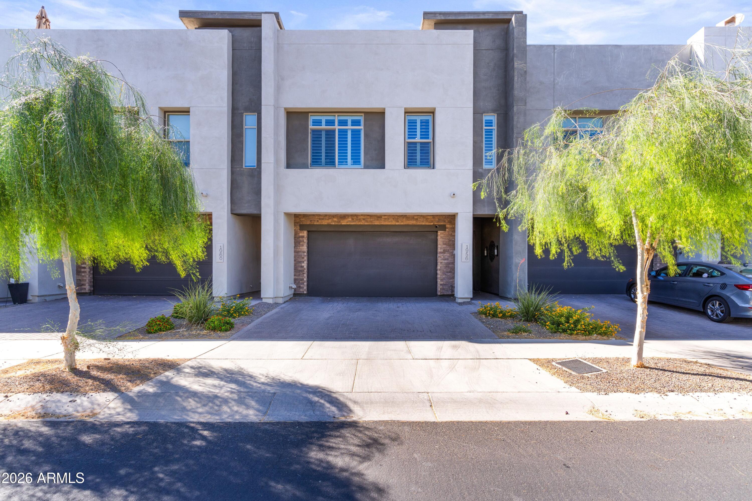 Welcome to 1956 West Kinfield Trail where every detail has been thoughtfully reimagined to create a truly turn-key luxury lifestyle. With nearly $75,000 in designer renovations, this 2,399-square-foot residence stands apart from anything else currently on the market. Designed for both entertaining and everyday living, the home offers two expansive living areas and a stunning chef's kitchen featuring a massive quartz island, gas cooktop, double ovens, and a generous walk-in pantry. Whether you're hosting friends or enjoying a quiet evening at home, every space feels warm, inviting, and effortlessly elegant. The large sliding glass doors open dramatically to your own outdoor oasis with a cozy gas fireplace, tranquil water fountain,  lush artificial turf, and a premium outdoor BBQ. Spend your evenings dining under the stars, relaxing to the soothing sounds of the fountain, or watching North Phoenix's famous cotton candy sunsets paint the mountain views beyond. This is outdoor living at its finest. Upstairs, the primary suite has been completely transformed into a spa-inspired sanctuary. The luxurious ensuite features high-end designer finishes, a beautifully renovated bathroom, and a state-of-the-art smart toilet, creating a private retreat you'll look forward to every day. Even the charming powder room has been thoughtfully redesigned, while the finished garage boasts epoxy flooring and custom built-in cabinetry for exceptional organization. Located in the highly sought-after Union Park community, residents enjoy a resort-style pool, parks, pickleball courts, walking paths, and a welcoming neighborhood atmosphere - all just minutes from The Shops at Norterra and TSMC.