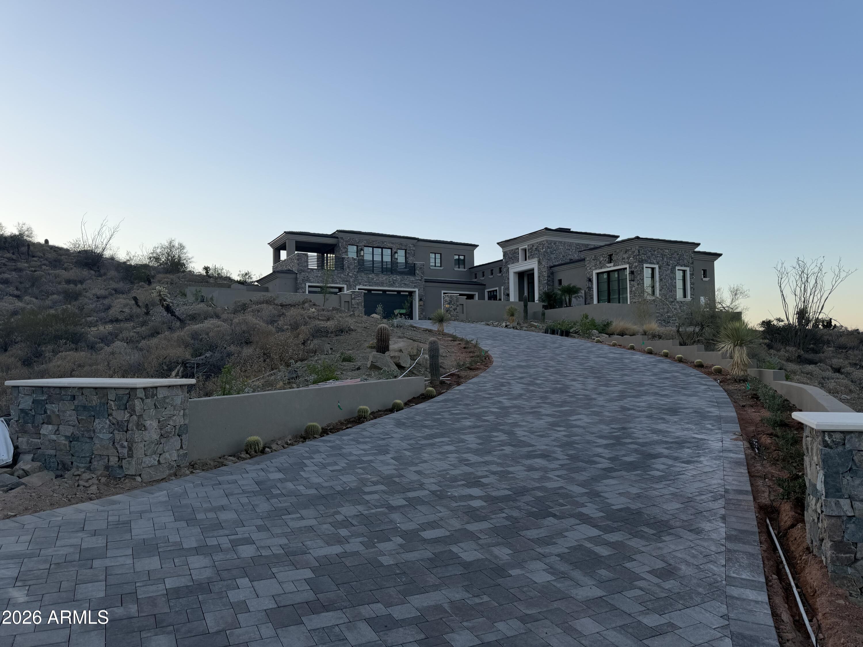 Gurczak Luxury Development is proud to present this New Construction Spec Home in the Exclusive Guard Gated Community of Eagles Nest. The design of the home reflects a two-story Modern Mediterranean style, utilizing varying textures and shades of warm neutral colors. This 4,410 Sq. Ft. Home Features 3 Bedrooms w/ ensuite bathrooms & additional bonus rooms including a Game Room & Office Upstairs. The shape and orientation of the home design takes advantage of the natural topography & North/South view corridors. The mixture of multi-colored stucco, stone, and limestone accents give varied texture and visual interest to the home, while the muted desert-tone colors allow the design to mesh with the landscape as well as sky when viewed from nearby angles. Estimated Completion May 2026.