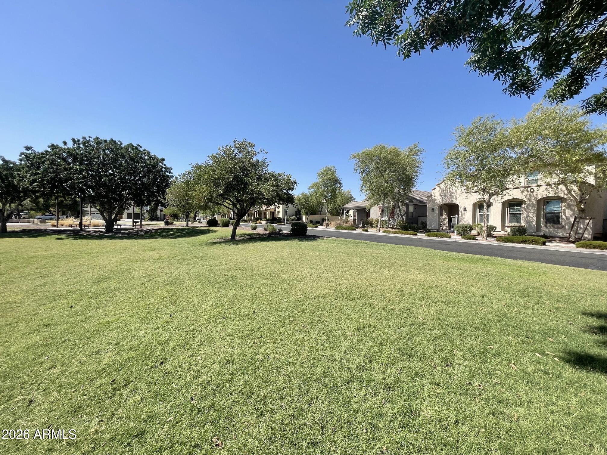 Rare opportunity to own an immaculate 2 story,5-bedroom home in the heart of Verrado overlooking Tempo Park, one of the community's most desirable locations.Just minutes from Verrado's newest shopping and dining destinations.Every detail has been completely upgraded and replaced with brand-new finishes,offering the peace of mind of a new build with immediate availability.What sets this property apart is its combination of size,location, and parking.With approx. 3,200 sq. ft.,a premium park-front lot, and parking for up to 6 veh. including a private 3-car rear-alley garage.Features include a first-floor primary suite, spacious loft with luxury vinyl plank flooring, and 4 oversized upstairs bedrooms. Enjoy mountain views, 86+ parks, 26 miles of trails, Heritage Swim Park, and Verrado Elem.
