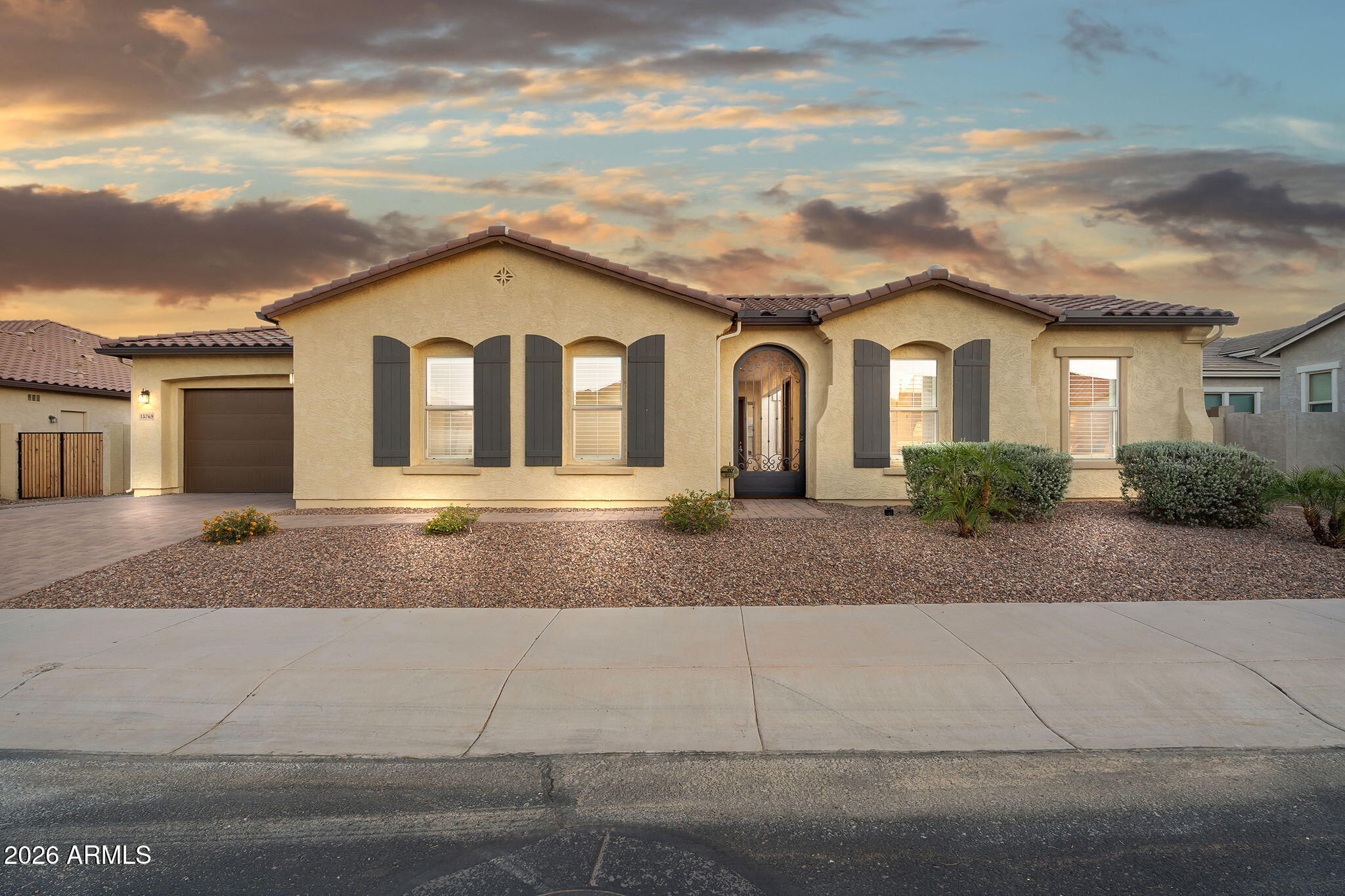 This luxury, gated Sunset Terrace home feels as though it were new, offering modern finishes and thoughtful upgrades throughout. Beyond the gated courtyard, you'll find a spacious great room with elevated ceilings, extensive tile flooring, and custom wood shutters. The chef's kitchen features premium cabinetry, quartz countertops, high-end appliances, and a generous pantry. The owner's suite provides a serene retreat with a soaking tub, walk-in shower, and dual closets. The backyard is designed for enjoyment with ample patio space and a putting green. A private casita with a full bath and kitchenette is ideal for guests or multigenerational living. The oversized 3-car garage includes a pass through. Walkable to shopping, a brand new high school and county library.
