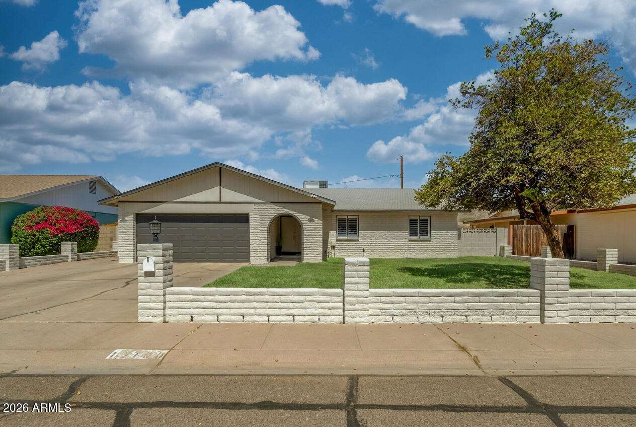 Welcome home to this beautifully maintained 3 bedroom, 2 bath residence ideally located directly across from Cave Creek Park - Cactus, offering easy access to green space, walking paths, and recreation. The updated kitchen features modern finishes and opens to comfortable living areas highlighted by a cozy fireplace. Step outside to your private backyard retreat with a sparkling pool complete with a fun slide, a spacious yard, and a covered patio perfect for entertaining or relaxing year-round. With no HOA restrictions, you'll enjoy added flexibility and freedom. Conveniently located near shopping, dining, schools, and major commuter routes, this home combines comfort, location, and outdoor living at its best.