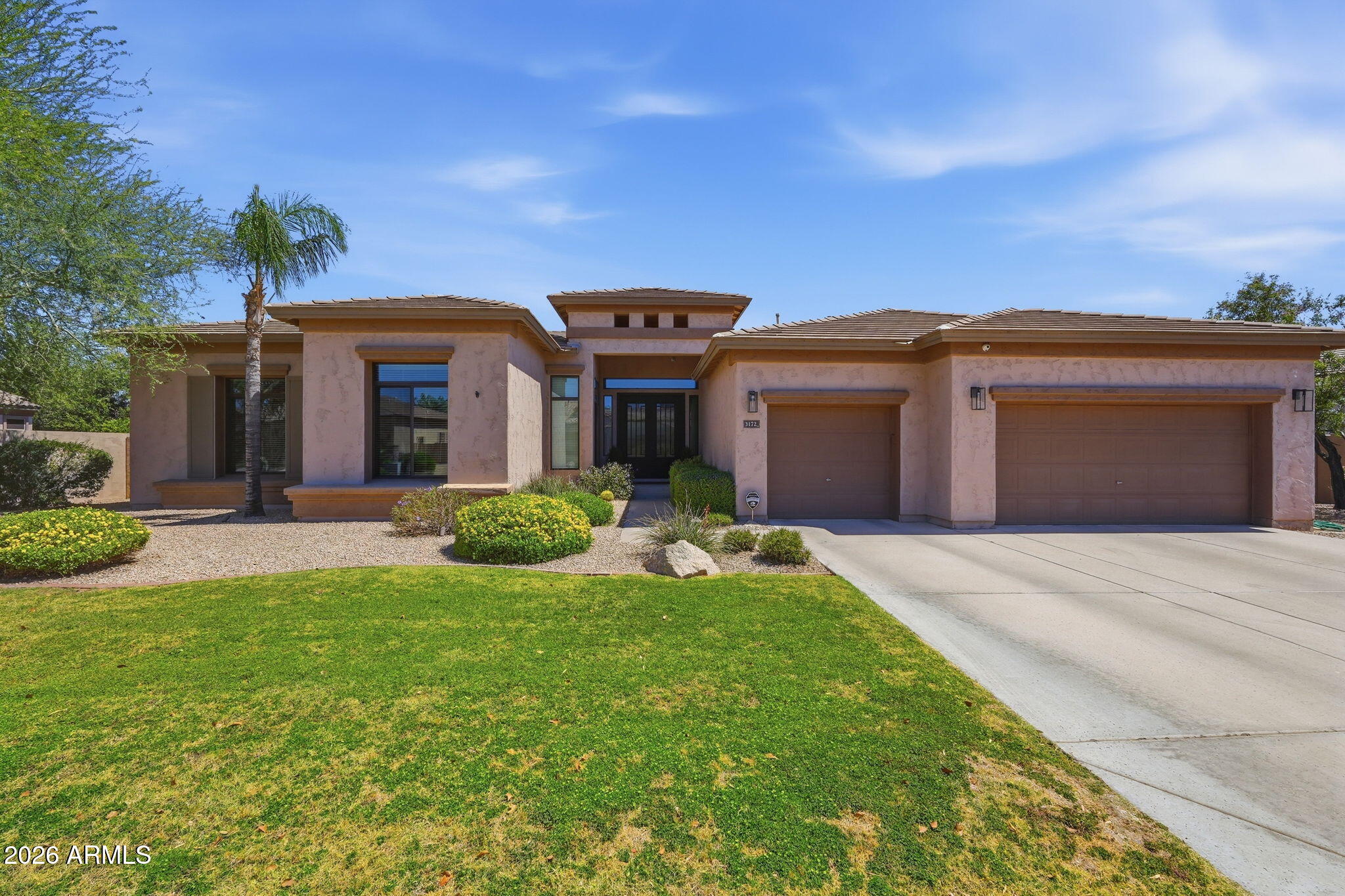 This stunning move-in ready home in Mesquite Grove Estates will wow you the second you walk through the iron doors.  Amazing views of the pool & spa & lush back yard when you enter the formal living & dining rooms.  Enter the fully renovated Chef's modern kitchen with slate Kitchen Aid appliances, gas cook-top, beautiful granite & back splash and warm tone cabinets. The huge center island is a gathering spot. The lighted stone media center in the spacious great room is a showcase of the room. This split floorplan home has 4 spacious bedrooms, 2.5 RENOVATED bathrooms plus a DEN. The lush back yard is great for entertaining with a built-in BBQ, putting green, firepit & water feature. The sparkling pool & spa are at the center of this beautiful, landscaped yard with a grassy area & patio.