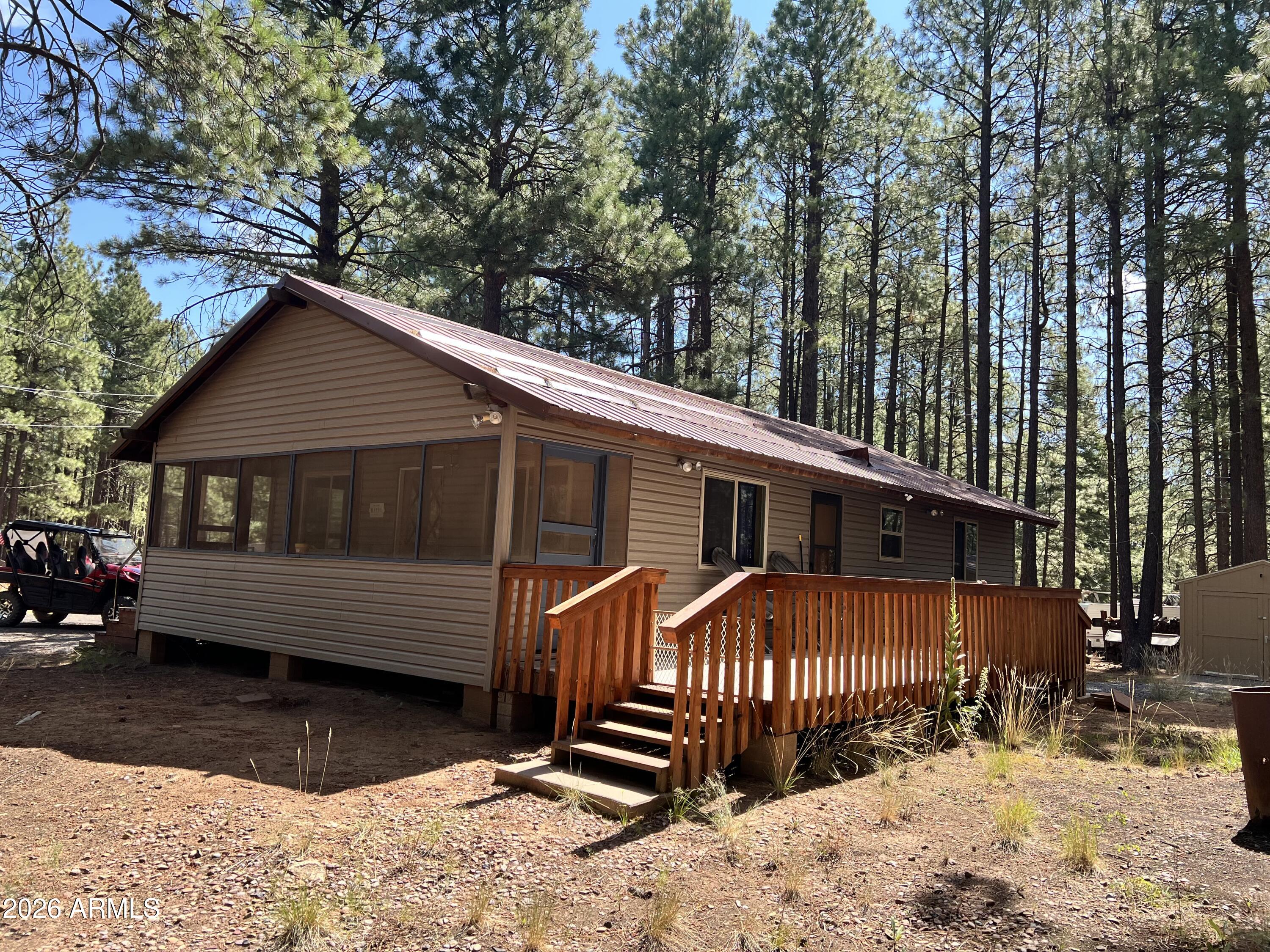 Escape the Phoenix heat to this charming mountain retreat in Forest Lakes. Located just an easy two-hour drive from the Valley, this high-elevation getaway offers scenic beauty and refreshing summer temperatures in the mid-70s.

Tucked off the beaten path and away from the busier neighborhood roads, this property enjoys minimal traffic and low dust, offering true peace and quiet. The cabin delivers that perfect, cozy cabiny aesthetic alongside a complete interior remodel. The inviting living space features warm spruce walls and ceilings, new luxury vinyl plank flooring throughout, a new wood-burning stove, and new windows that fill the home with natural light.

Practical updates provide absolute peace of mind, including a new water heater, a beautifully tiled shower, and a fully fire-w ... lot. Outside, the attached deck is perfect for enjoying the cool mountain weather, and the property includes two storage sheds. Whether you are looking for a weekend escape or a turnkey mountain getaway, this adorable Forest Lakes gem is ready for its next chapter.