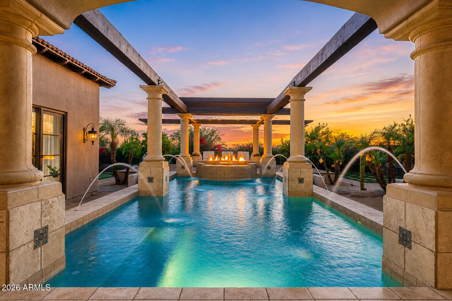 Situated within the guard-gated Raptor Retreat in Serenity at Grayhawk, this custom estate offers a private setting backing to natural area open space, creating a quiet and secluded feel while still capturing the community's elevated beauty. A long paved drive leads to the portico entry and four-car garage, setting the stage for a home with recent upgrades including new interior and exterior paint and new light fixtures throughout. The entry opens to formal living and dining spaces, highlighted by a box beam ceiling in the living room and a coved ceiling in the dining area. Wood casement doors and windows add warmth and character throughout. Designed for both everyday living and entertaining, the kitchen opens to the family room with a stone fireplace. The kitchen features stainless steel appliances, a gas cooktop, double wall ovens, two dishwashers, two microwaves, a warming drawer, a large center island with a prep sink and seating, peninsula bar seating, and a breakfast room. A butler's pantry includes a sink, additional storage, beverage/wine refrigerator, two refrigerator drawers and convenient exterior access.

The main level includes a private office with its own entry, along with a spacious primary suite designed as a true retreat. Complete with a stacked stone fireplace and sitting area, the primary suite also features a spa-like bath with a his-and-hers setup, including a centerpiece soaking tub, walk-in shower, dual vanities, an exercise room, and a large walk-in closet. A private enclosed patio with outdoor shower enhances the indoor-outdoor connection.

Upstairs, two guest suites each offer private baths, along with a flexible bonus space currently styled as a playroom with foam pit and rock wall, easily converted to a media room or additional lounge. A detached casita provides ideal guest accommodations with a kitchenette, microwave, beverage refrigerator, sink, bedroom, and bath.

The backyard is an entertainer's dream, thoughtfully designed with a large covered patio and fireplace, built-in grilling area, and expansive hardscape. The rectangular pool is flanked by columns and water features, leading to a pergola-covered lounge space. A separate spa, artificial turf areas, citrus trees, a fire pit and a three-hole putting green complete the setting.

Serenity at Grayhawk is an exclusive enclave of just 33 custom homesites known for its elevated lots, privacy, and access to Grayhawk's extensive amenities, including parks, trails, and community features, all just minutes from shopping, dining, and the Loop 101.