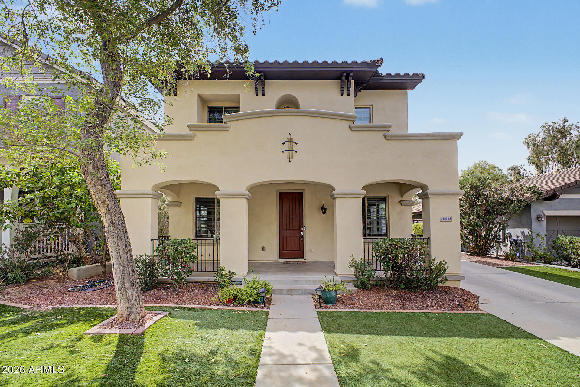 Beautiful, Single Story Pulte home located within the highly coveted Verrado community, residents enjoy picturesque tree-lined streets, championship golf, scenic hiking trails, parks, and a vibrant Main Street, Sunrise Market and brand new Verrado Marketplace all filled with dining, boutique shopping, and entertainment--offering a rare blend of small-town charm and elevated lifestyle amenities all just North or South of home.
Its charming front porch sits directly across from Poets Park and the rest speaks for itself: granite counters, stainless steel appliances and inviting FP. Experience desert living in this wonderfully maintained 3-bedroom, 2.5-bath residence with a spacious loft, ideally situated in the heart of Verrado. Thoughtfully designed and in good condition, this home provides a seamless backdrop to entertain or cozy up with family. From the moment you enter, you're welcomed by an abundance of natural light, elevated finishes, and a flowing open-concept  layout designed for both everyday living and elegant entertaining. The chef-inspired kitchen opens beautifully to the main living space, creating an inviting atmosphere for gatherings both large and intimate. Upstairs, the versatile loft provides a refined flex space--perfect for a private office, media lounge, or additional retreat. The backyard, a very private space, features green grass, covered patio, a serene setting encouraging relaxation and room for details to be added. Whether enjoying quiet mornings or hosting sunset gatherings, this outdoor space delivers both! Make time to come and see this one!