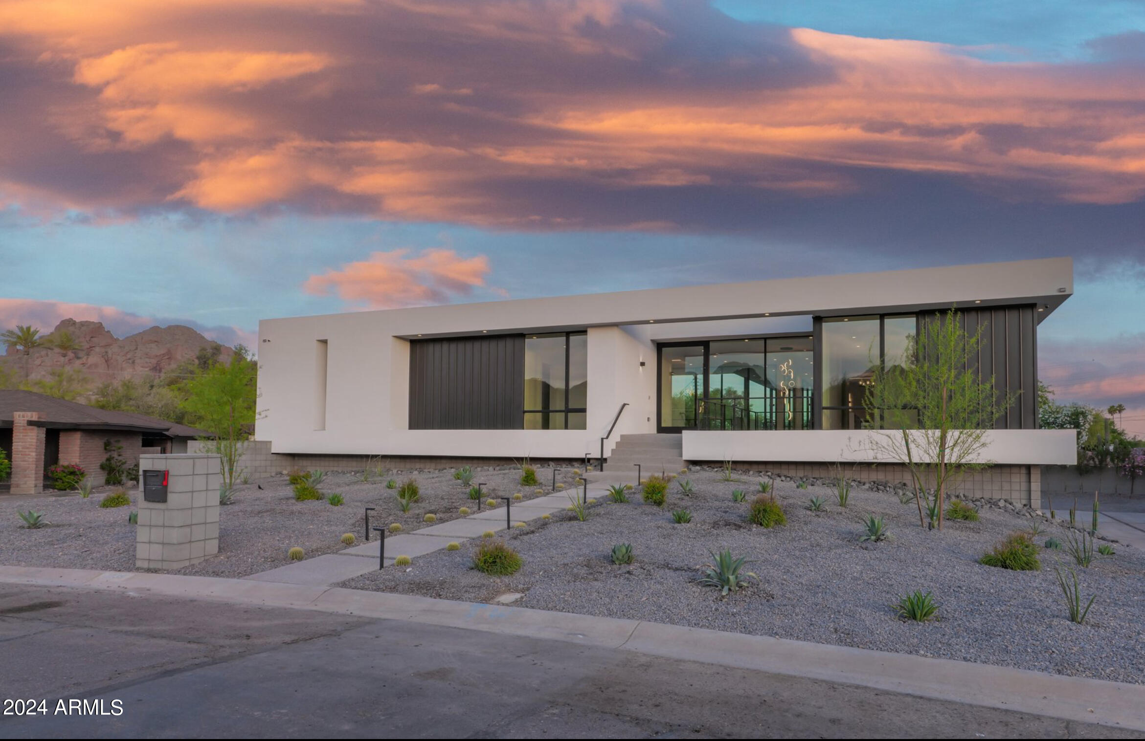 NEW BUILD on the border of the Arcadia area & Paradise Valley. If you enjoy entertaining, this home is a must see. Floor to ceiling windows, & sliding glass walls create the perfect picture frame for views of the Phx mtn preserve to the north & Camelback to the east. The natural light is incredible. The main level consists of a gourmet kitchen featuring Wolf Subzero appliance package, custom cabinetry, large island, hidden prep kitchen, main living area, 3 beds w/en-suites including the primary suite. Primary suite includes a fireplace, spa bath, custom walk in closet w/laundry area, & private balcony over looking the backyard oasis. The lower level offers 2 of the en-suites, a flex space for gym/office, & 2nd entertainment space w/bar. The home is also equipped w/smart home automation 1/2 acre lot includes an outdoor kitchen, fireplace, heated pool & spa, & 1800+ SF of covered space. The lot coverage was not maxed out like most new builds. Just minutes away from the Phoenix Suns practice facility, Phoenix Country Day School, as well as some of the areas best hotspots like Steak 44, The Henry, Chelsea's Kitchen, North Italia, and all the amenities the new Global Ambassador Hotel has to offer. Close proximity to Old Town Scottsdale and Phoenix Sky Harbor airport.